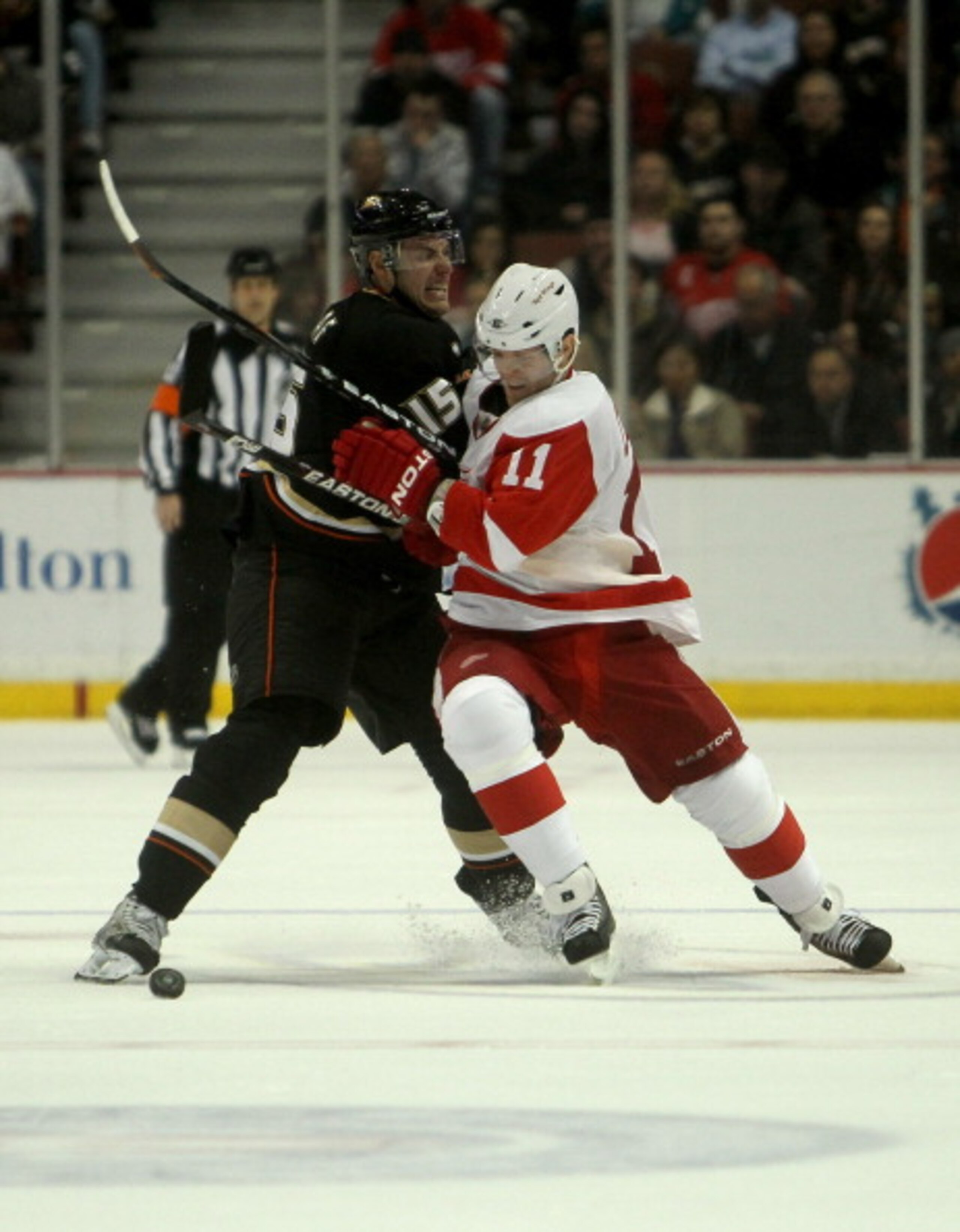 ANAHEIM, CA - MARCH 02:  Danny Cleary #11 of the Detroit Red Wings is tied up at center ice by Ryan Getzlaf #15 of the Anaheim Ducks on March 2, 2011 at the Honda Center in Anaheim, California.   The Ducks won 2-1 in overtime.  (Photo by Stephen Dunn/Gett