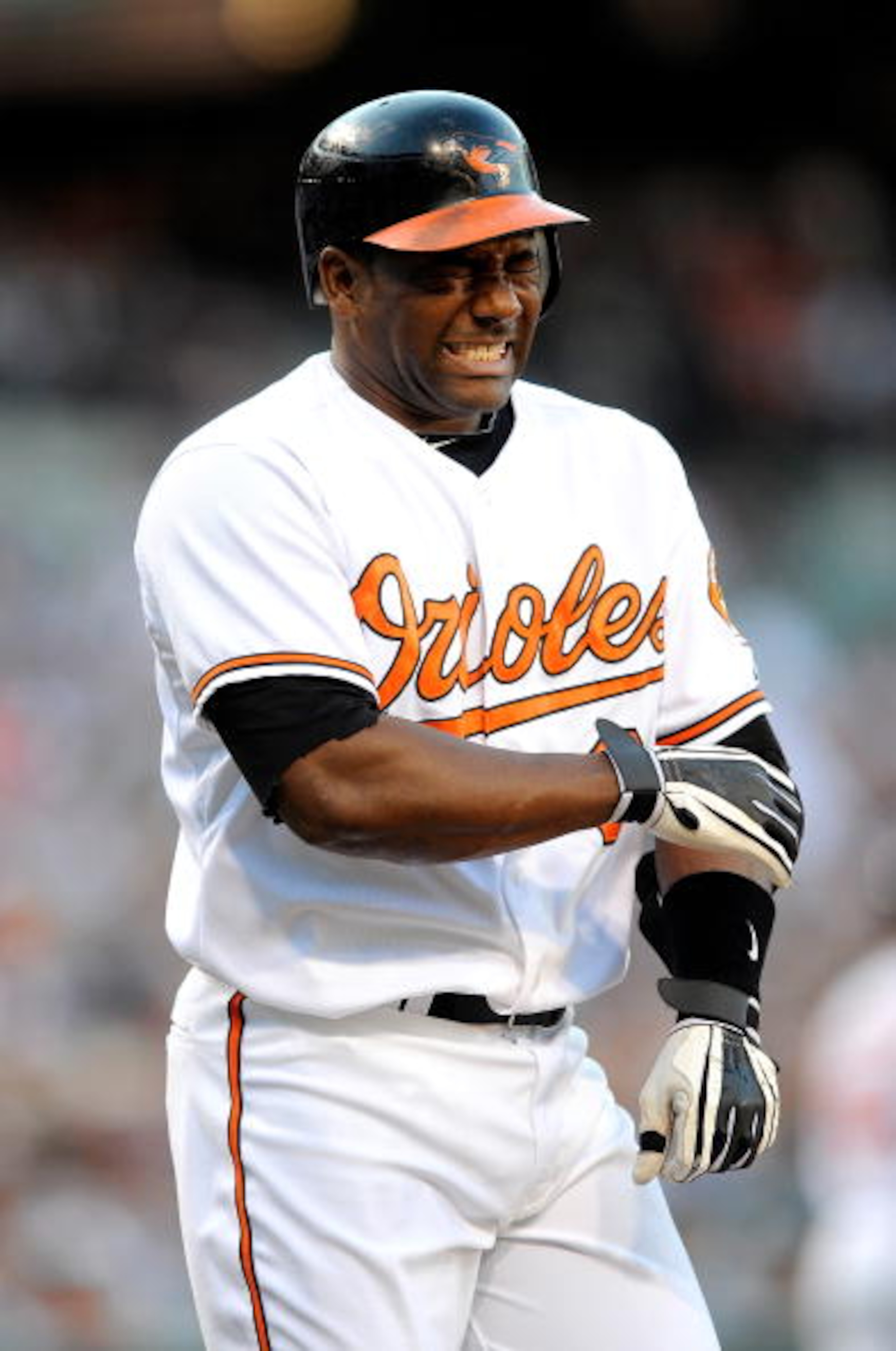 BALTIMORE - JUNE 10:  Miguel Tejada #9 of the Baltimore Orioles winces after getting hit by a pitch during the game against the New York Yankees at Camden Yards on June 10, 2010 in Baltimore, Maryland.  (Photo by Greg Fiume/Getty Images)