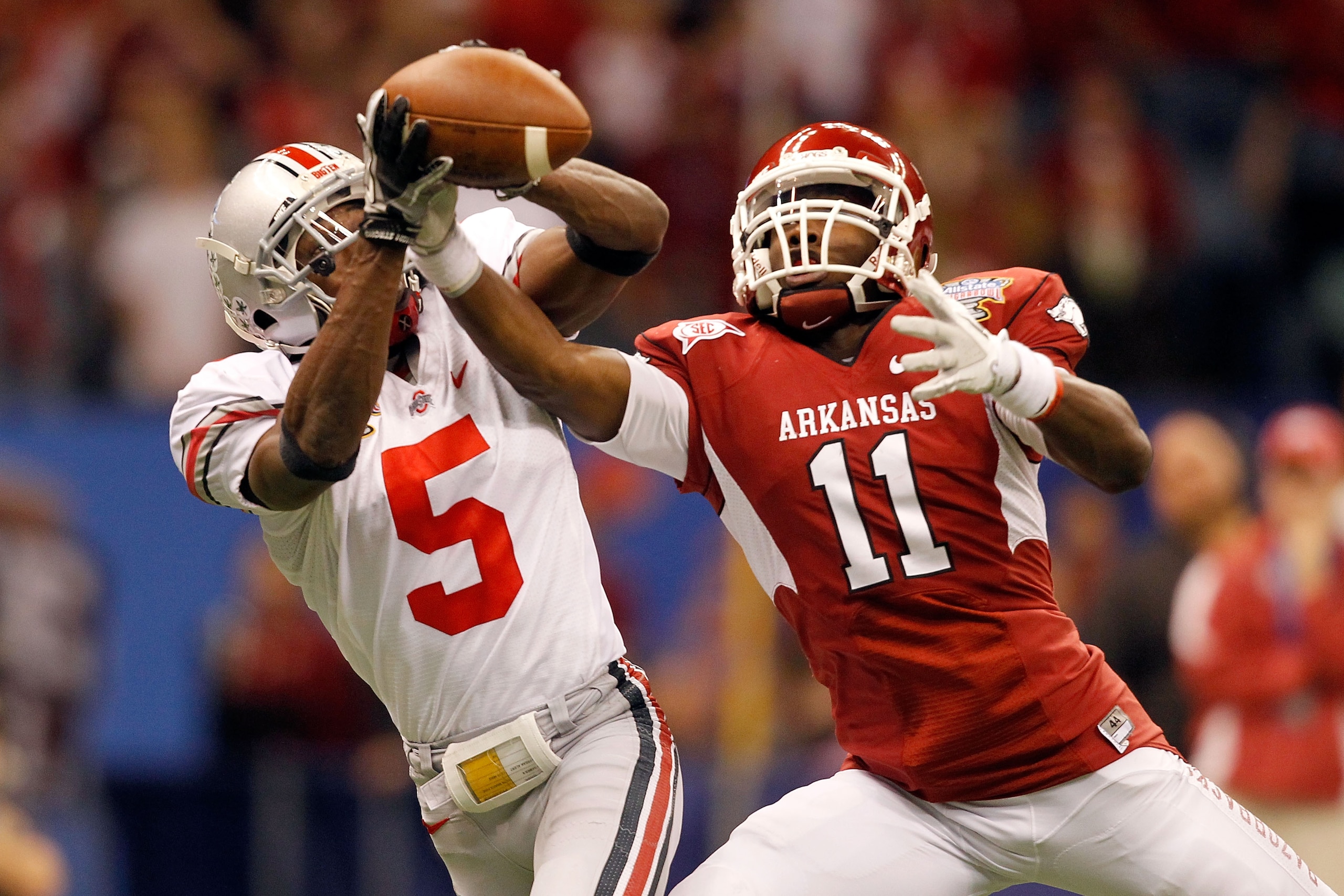 NEW ORLEANS, LA - JANUARY 04:  Chimdi Chekwa #5 of the Ohio State Buckeyes is unable to come up with an interception as he goes up for the ball against Cobi Hamilton #11 of the Arkansas Razorbacks in the second quarter during the Allstate Sugar Bowl at th