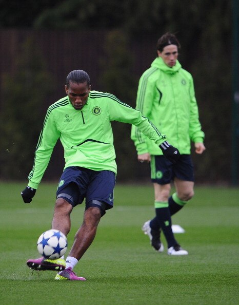 COBHAM, ENGLAND - APRIL 05:  Didier Drogba of Chelsea shoots as team mate Fernando Torres looks on during a Chelsea training session ahead of their UEFA Champions League Quarter-final first leg match against Manchester United, at the Chelsea Football Club