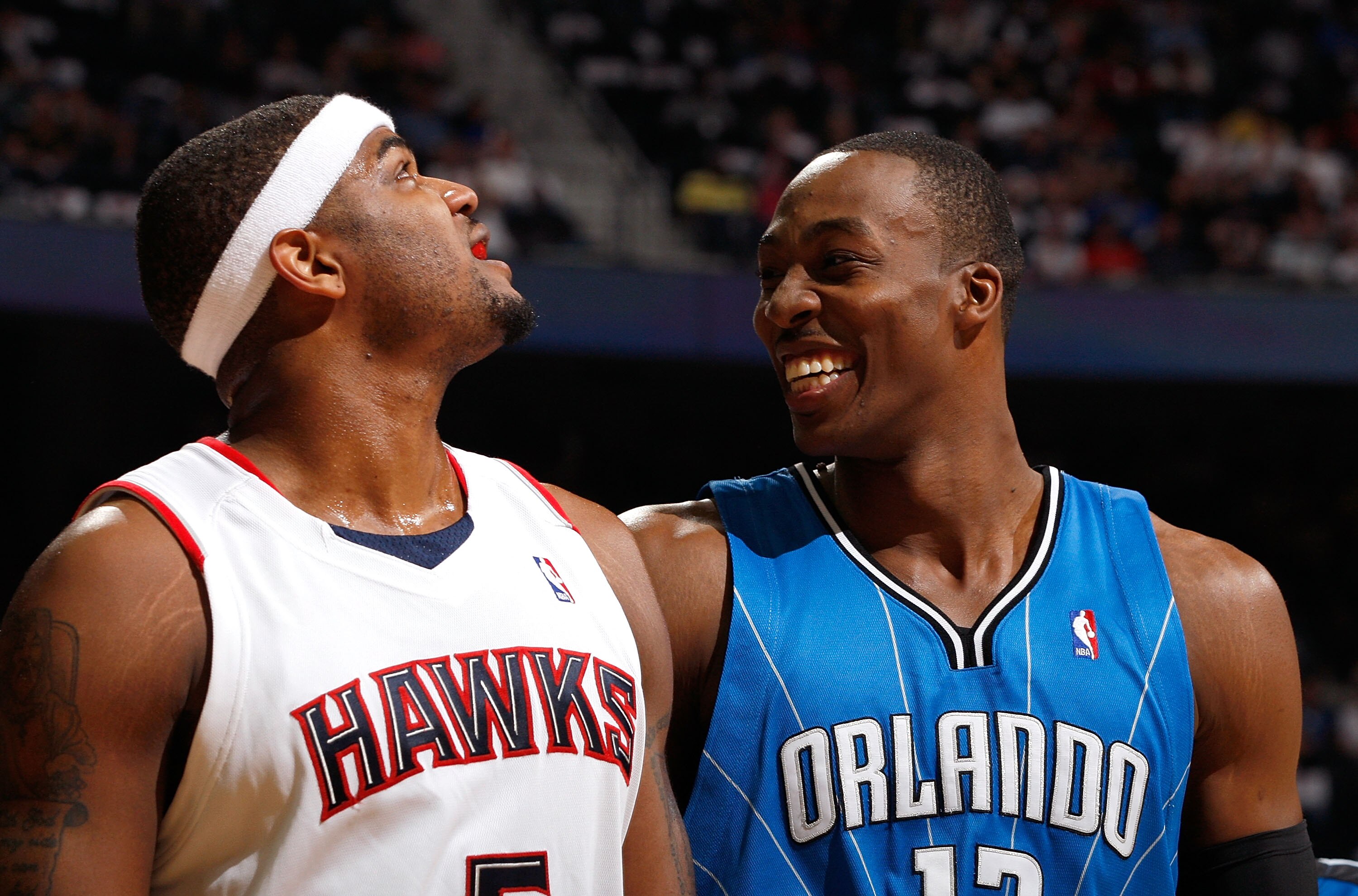 ATLANTA - MAY 10:  Dwight Howard #12 of the Orlando Magic enjoys a laugh at a parody about him on the big screen next to Josh Smith #5 of the Atlanta Hawks during Game Four of the Eastern Conference Semifinals of the 2010 NBA Playoffs at Philips Arena on