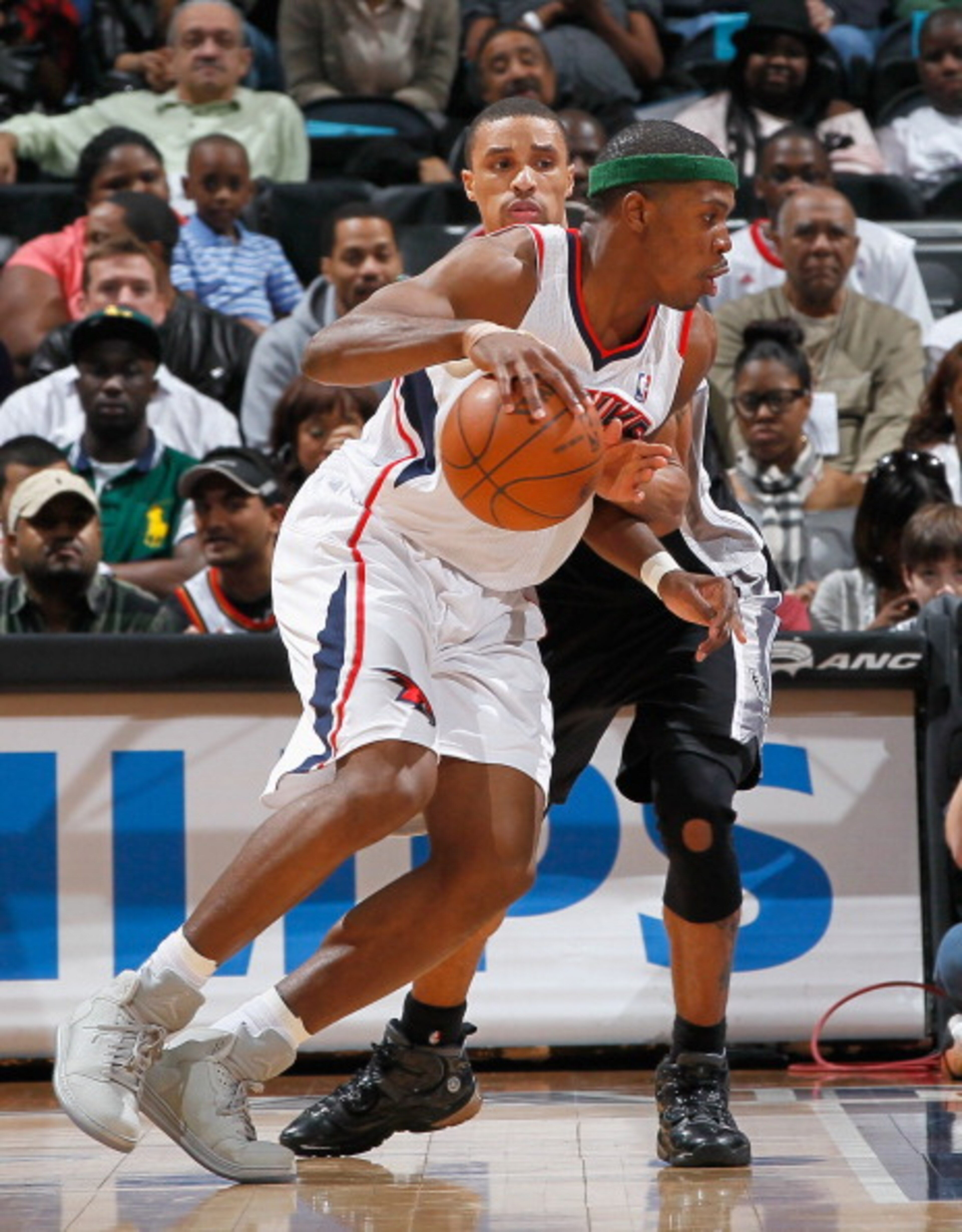 ATLANTA, GA - APRIL 05:  Joe Johnson #2 of the Atlanta Hawks against George Hill #3 of the San Antonio Spurs at Philips Arena on April 5, 2011 in Atlanta, Georgia.  NOTE TO USER: User expressly acknowledges and agrees that, by downloading and/or using thi