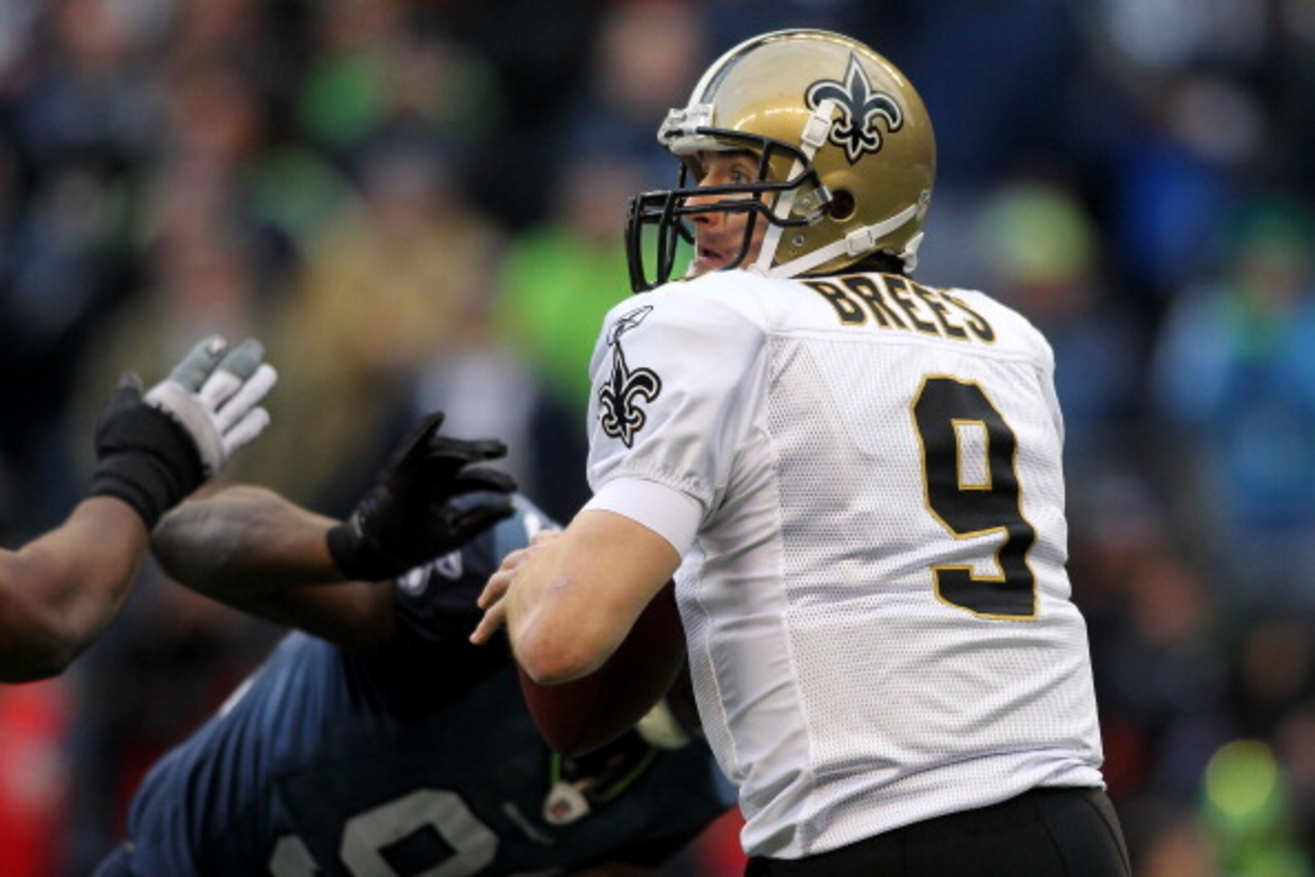 SEATTLE, WA - JANUARY 08:  Quarterback Drew Brees #9 of the New Orleans Saints scrambles against the Seattle Seahawks during the 2011 NFC wild-card playoff game at Qwest Field on January 8, 2011 in Seattle, Washington.  (Photo by Jonathan Ferrey/Getty Ima