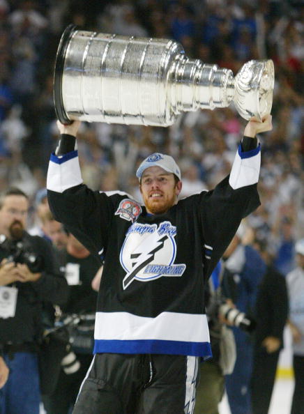 TAMPA, FL - JUNE 7:   Brad Richards #19 of the Tampa Bay Lightning holds the Stanley Cup above his head after the victory over the Calgary Flames in Game seven of the NHL Stanley Cup Finals on June 7, 2004 at the St. Pete Times Forum in Tampa, Florida. Th