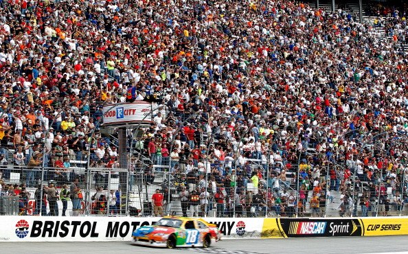 BRISTOL, TN - MARCH 20: Kyle Busch, driver of the #18 M&M's Toyota, takes the checkered flag to win the NASCAR Sprint Cup Series Jeff Byrd 500 Presented By Food City at Bristol Motor Speedway on March 20, 2011 in Bristol, Tennessee.  (Photo by Geoff Burke