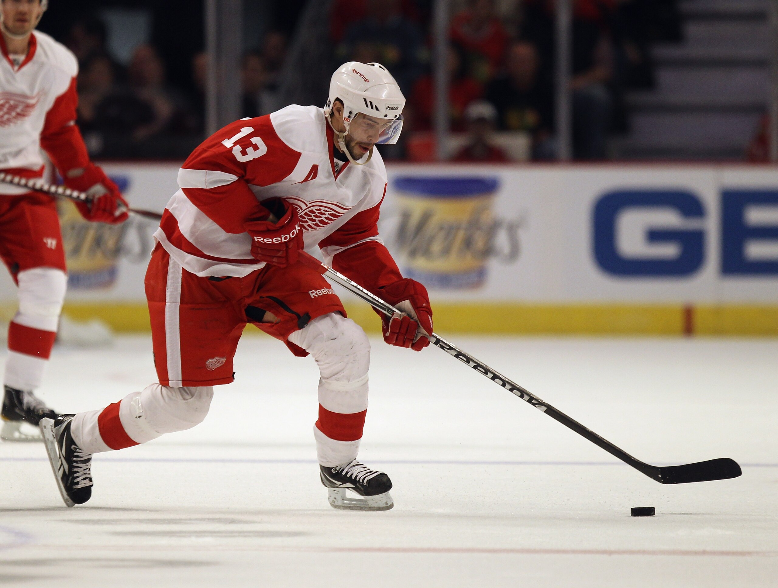 CHICAGO, IL - APRIL 10: Pavel Datsyuk #13 of the Detroit Red Wings skates to the puck against the Chicago Blackhawks at the United Center on April 10, 2011 in Chicago, Illinois. The Red Wings defeated the Blackhawks 4-3. (Photo by Jonathan Daniel/Getty Im