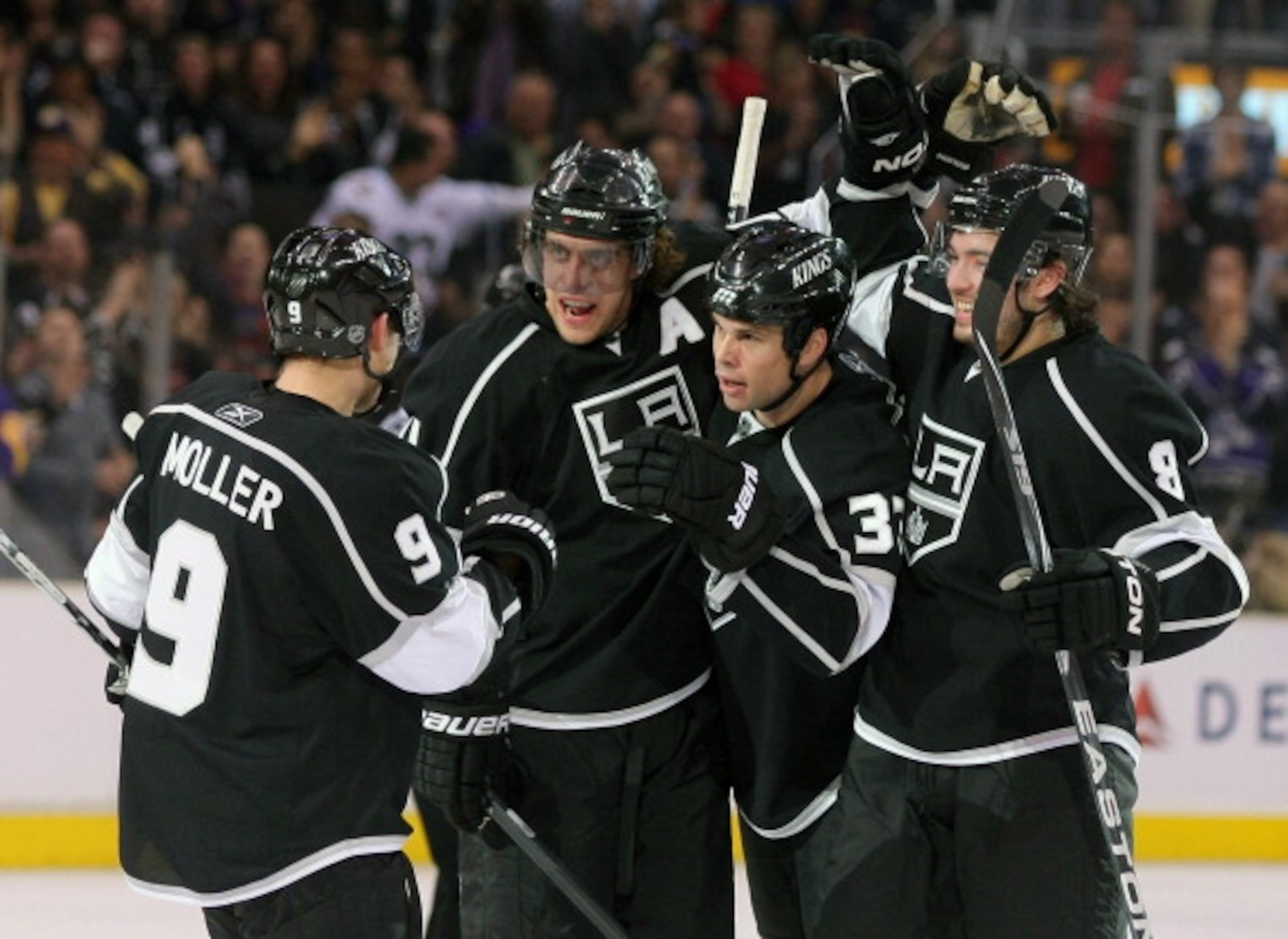 LOS ANGELES, CA - MARCH 24:  Willie Mitchell #33 of the Los Angeles Kings celebrates his goal with teammates Oscar Moller #9, Anze Kopitar #11 and Drew Doughty #8 in the second period during the NHL game against the San Jose Sharks at Staples Center on Ma