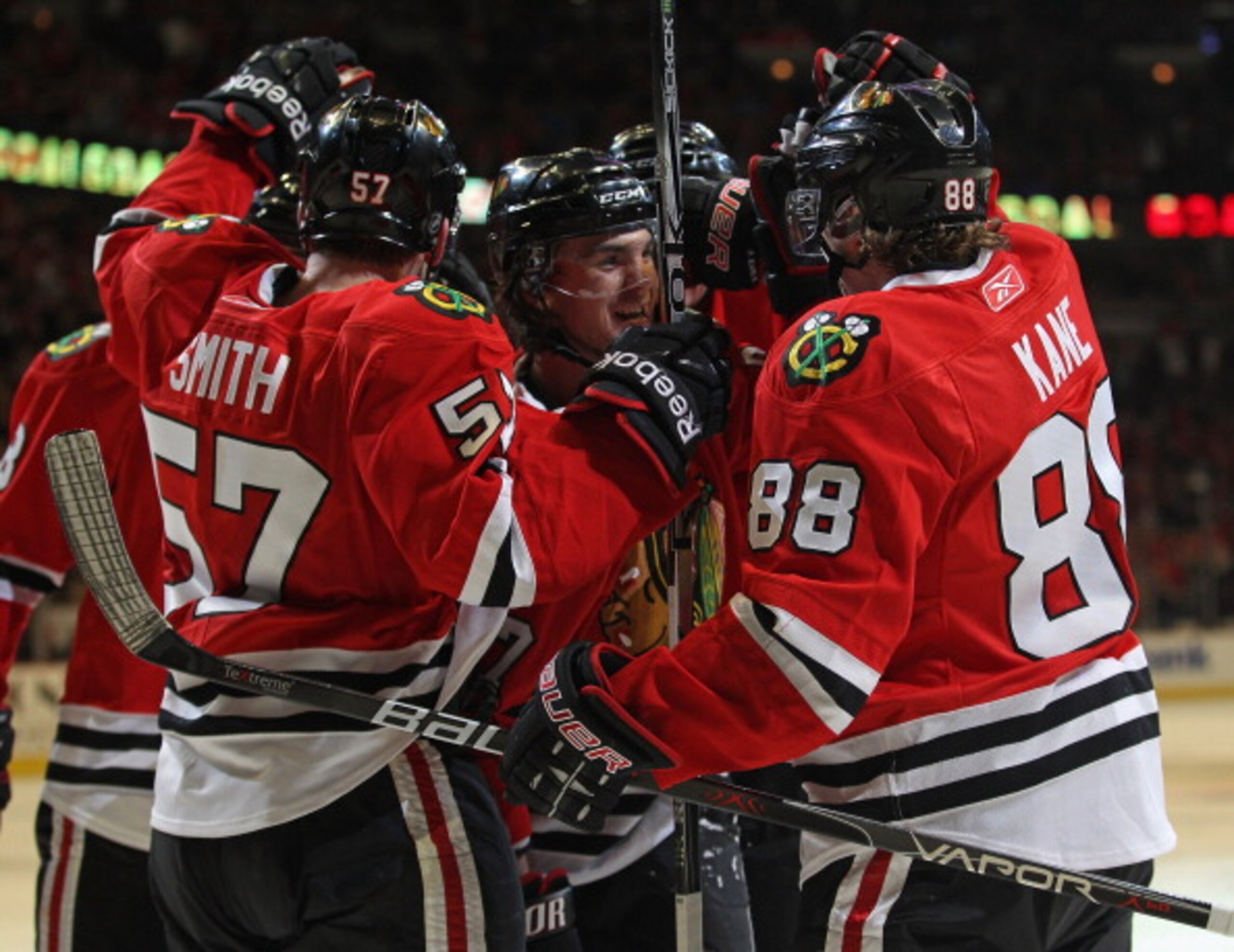 CHICAGO, IL - APRIL 10: Michael Frolik #67 of the Chicago Blackhawks (center) is congratulated by teammates including Ben Smith #57 and Patrick Kane #88 after scoring a goal in the 2nd period against the Detroit Red Wings at the United Center on April 10,