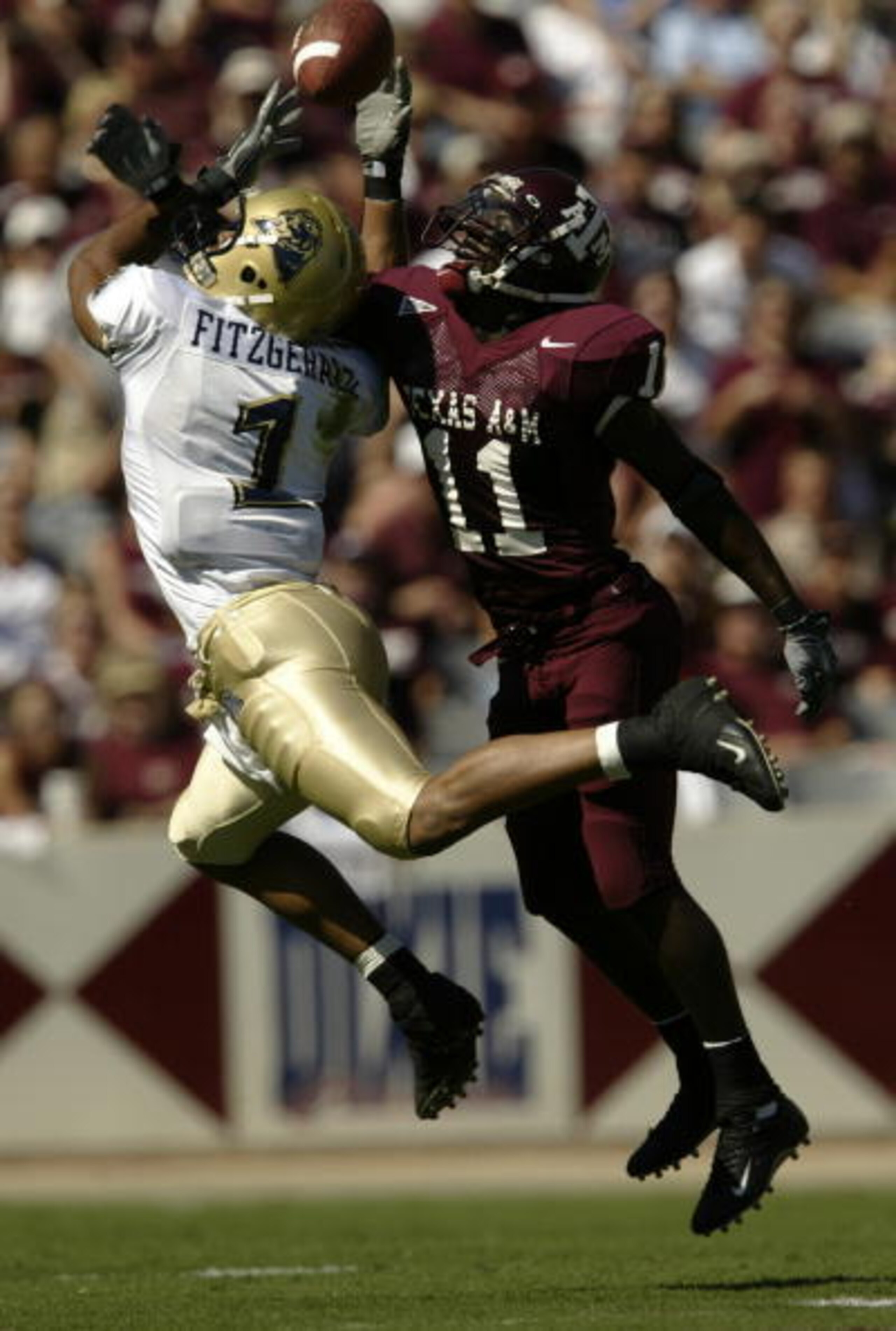 COLLEGE STATION, TX - SEPTEMBER 27:  Wide receiver Larry Fitzgerald #1 of the University of Pittsburgh Panthers nearly catches a pass near defensive back Byron Jones #11 of the Texas A&M University Aggies at Kyle Field on September 27, 2003 in College Sta