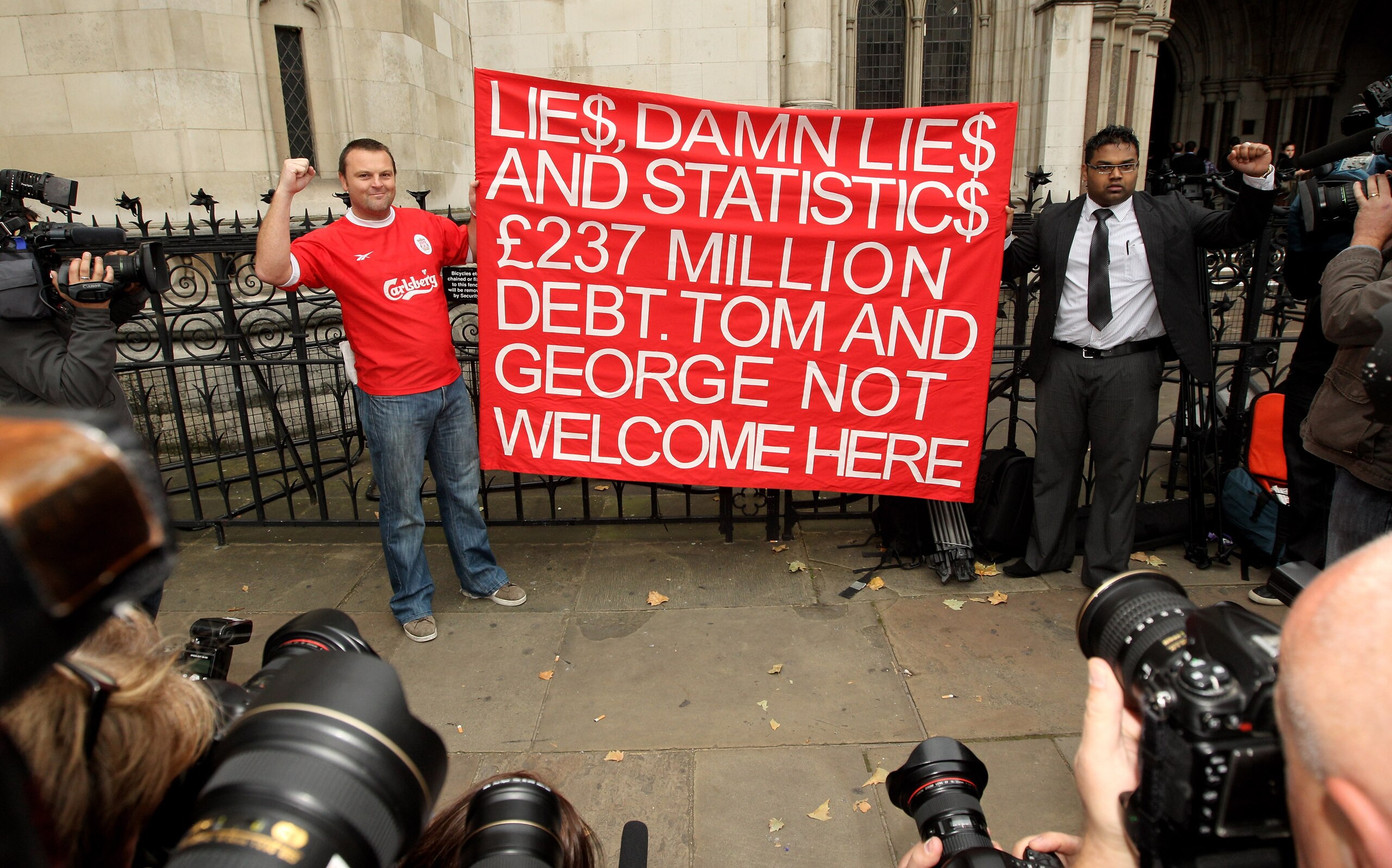 LONDON, ENGLAND - OCTOBER 12:  Supporters of Liverpool Football Club demonstrate outside the High Court on October 12, 2010 in London, England. The Royal Bank of Scotland, which holds the majority of Liverpool's debts, is seeking a high court order to pre