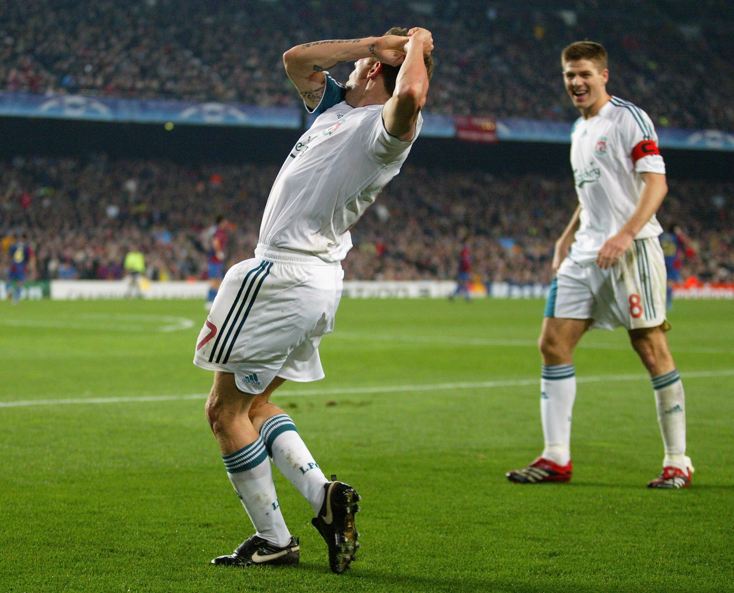 BARCELONA, SPAIN - FEBRUARY 21:  Craig Bellamy of Liverpool celebrates with a golf swing after scoring his goal during the UEFA Champions League round of 16 first leg match between Barcelona and Liverpool at the Nou Camp Stadium on February 21, 2007 in Ba