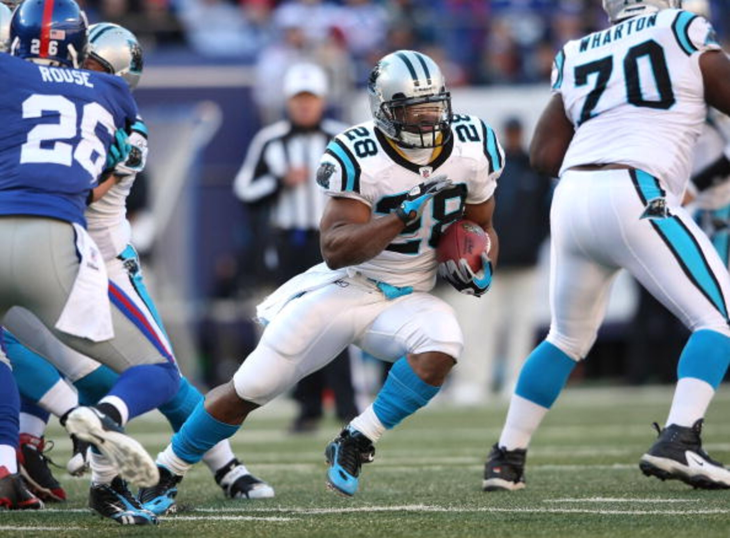 EAST RUTHERFORD, NJ - DECEMBER 27: Jonathan Stewart #28 of the Carolina Panthers rushes against the New York Giants at Giants Stadium on December 27, 2009 in East Rutherford, New Jersey.  (Photo by Nick Laham/Getty Images)