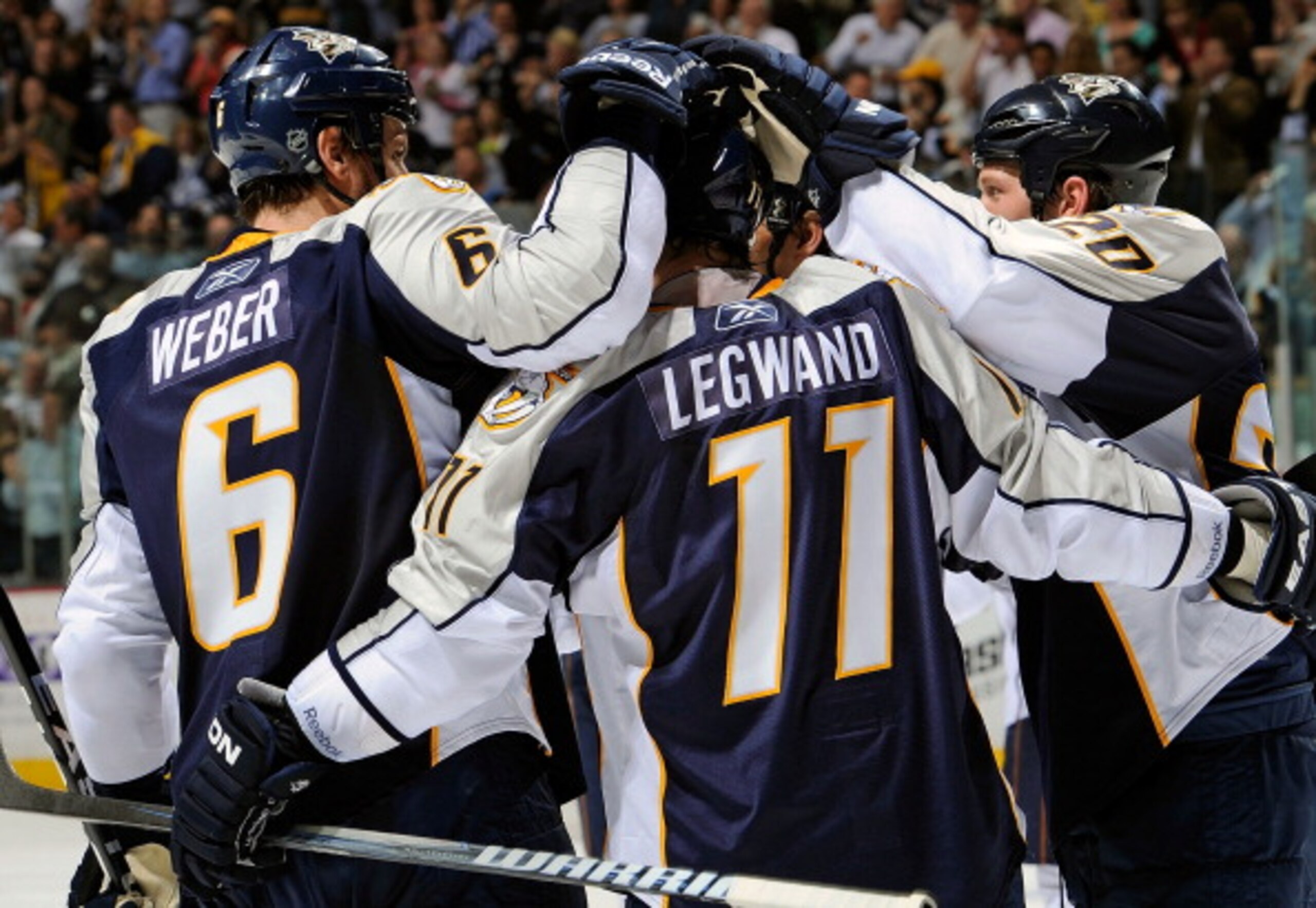 NASHVILLE, TN - MARCH 22:  Shea Weber #6 and Ryan Suter #20 of the Nashville Predators congratulate teammate David Lewand #11 on scoring a goal against the Edmonton Oilers on March 22, 2011 at the Bridgestone Arena in Nashville, Tennessee.  (Photo by Fred