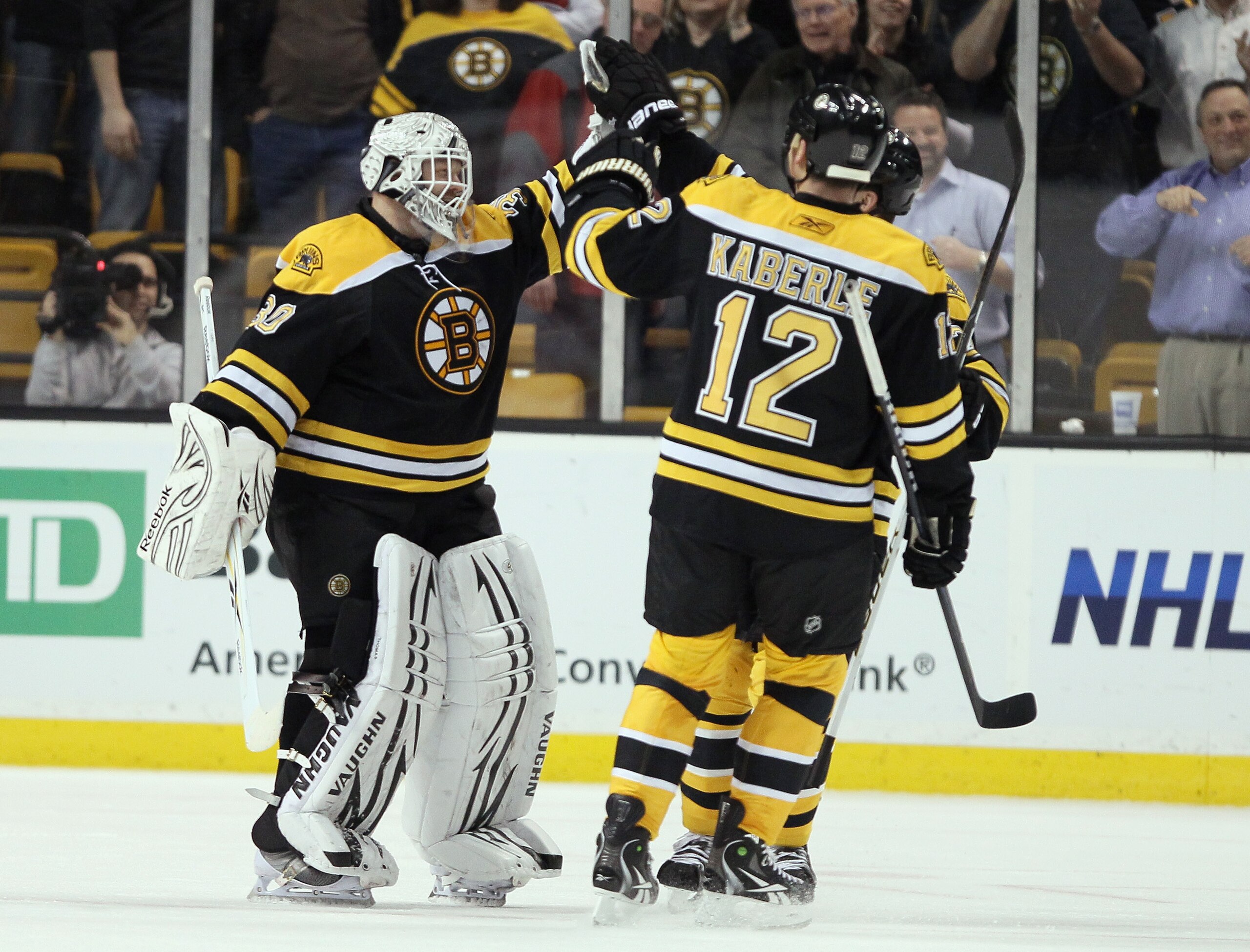 BOSTON, MA - MARCH 24:  Tim Thomas #30 of the Boston Bruins is congratulated by teammates Tomas Kaberle #12 and Patrice Bergeron #37 after Thomas shut out the Montreal Canadiens on March 24, 2011 at the TD Garden in Boston, Massachusetts.  The Boston Brui