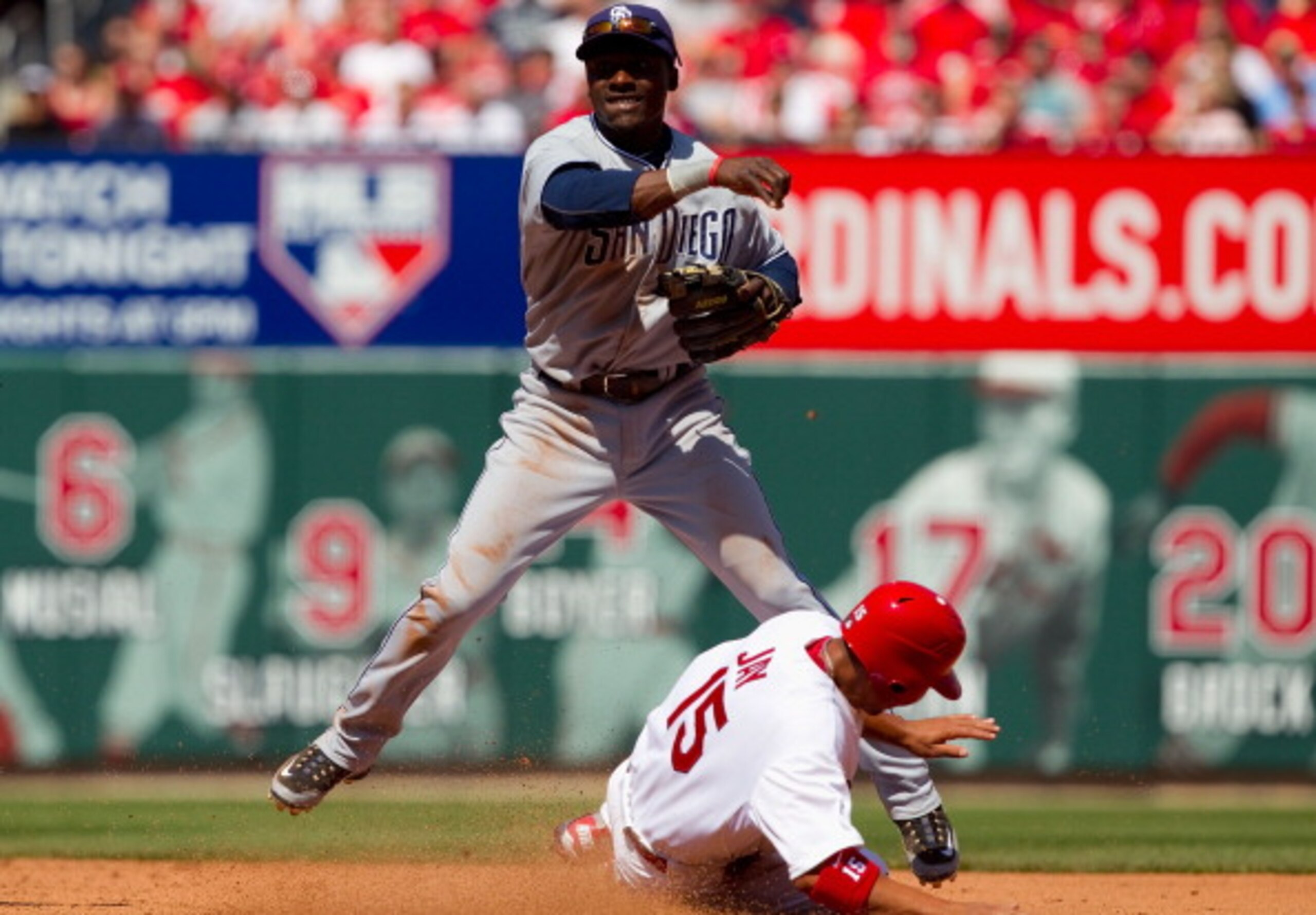ST. LOUIS, MO - APRIL 3: Orlando Hudson #1 of the San Diego Padres turns a double play over Jon Jay #15 of the St. Louis Cardinals at Busch Stadium on April 3, 2011 in St. Louis, Missouri.  (Photo by Dilip Vishwanat/Getty Images)
