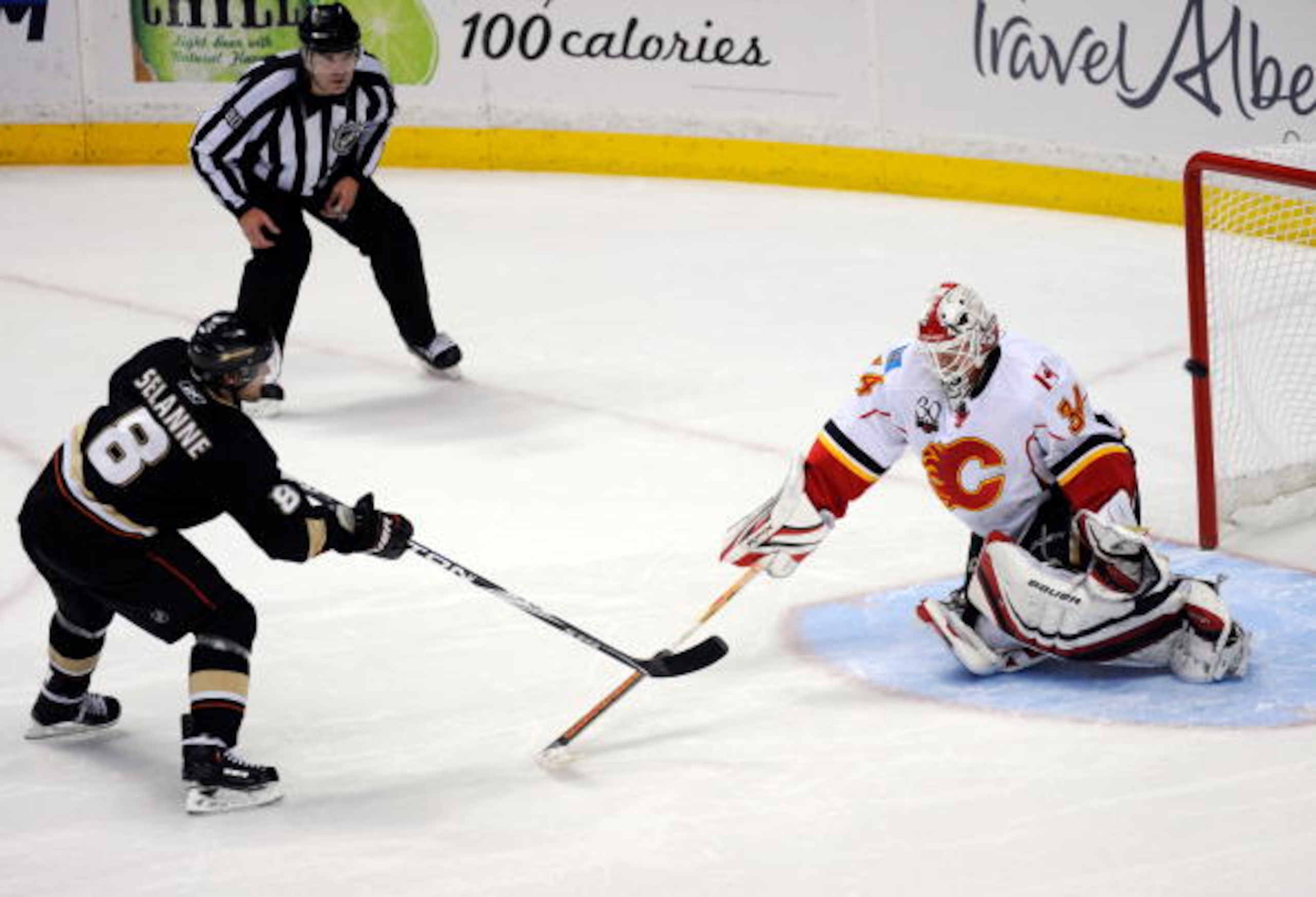 ANAHEIM, CA - NOVEMBER 23: Teemu Selanne #8 of the Anaheim Ducks scores the winning goal against Mikka Kiprusoff #34 goalkeeper of the Calgary Flames during the shootout of the NHL game at the Honda Center on November 23, 2009 in Anaheim, California.  Nys