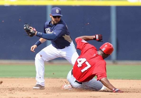 PEORIA, AZ - MARCH 15:  Howard Kendrick #47 of the Los Angeles Angels of Anaheim safely slides into second base past the tag from infielder Jason Bartlett #8 of the San Diego Padres during the spring training game at Peoria Stadium on March 15, 2011 in Pe