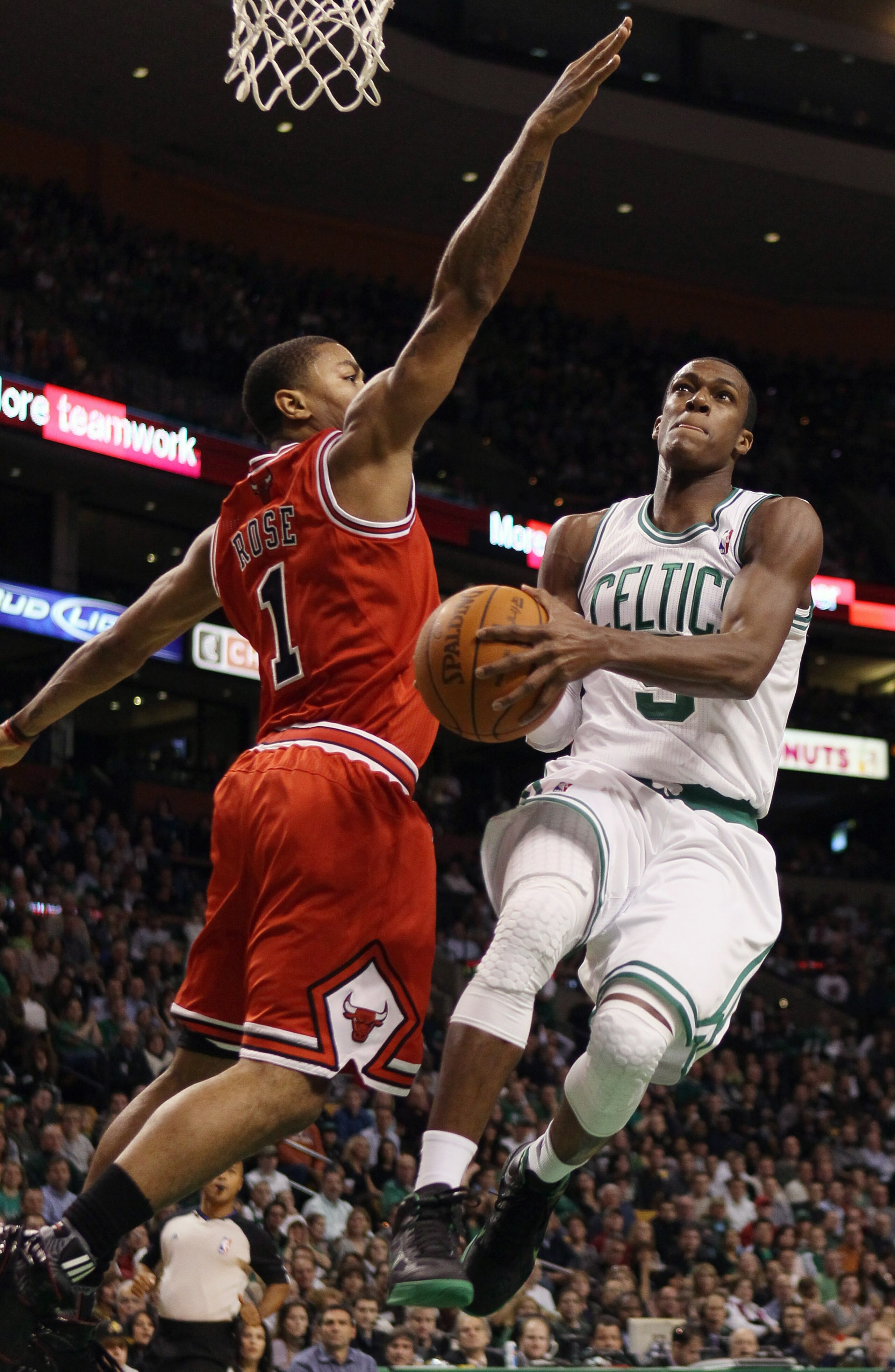 BOSTON, MA - NOVEMBER 05: Rajon Rondo #9 of the Boston Celtics takes a shot as Derrick Rose #1 of the Chicago Bulls defends on November 5, 2010 at the TD Garden in Boston, Massachusetts. NOTE TO USER: User expressly acknowledges and agrees that, by down BOSTON, MA - NOVEMBER 05: Rajon Rondo #9 of the Boston Celtics takes a shot as Derrick Rose #1 of the Chicago Bulls defends on November 5, 2010 at the TD Garden in Boston, Massachusetts. NOTE TO USER: User expressly acknowledges and agrees that, by down