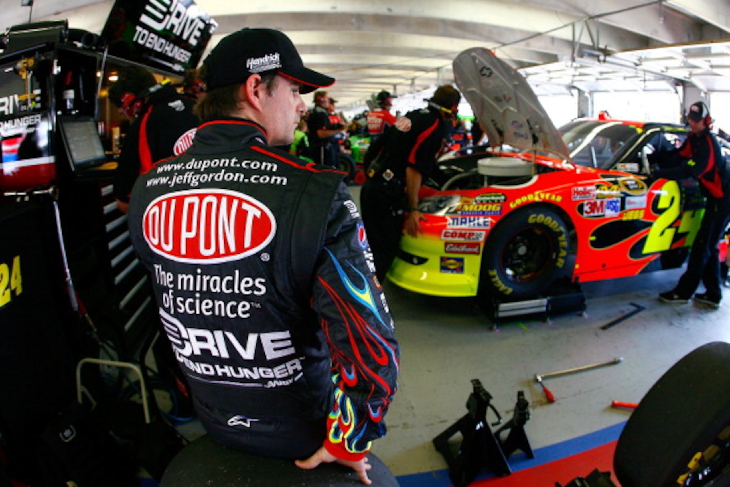 FORT WORTH, TX - APRIL 08:  Jeff Gordon (L), driver of the #24 DuPont Chevrolet, sits in the garage during practice for the NASCAR Sprint Cup Series Samsung Mobile 500 at Texas Motor Speedway on April 8, 2011 in Fort Worth, Texas.  (Photo by Jason Smith/G