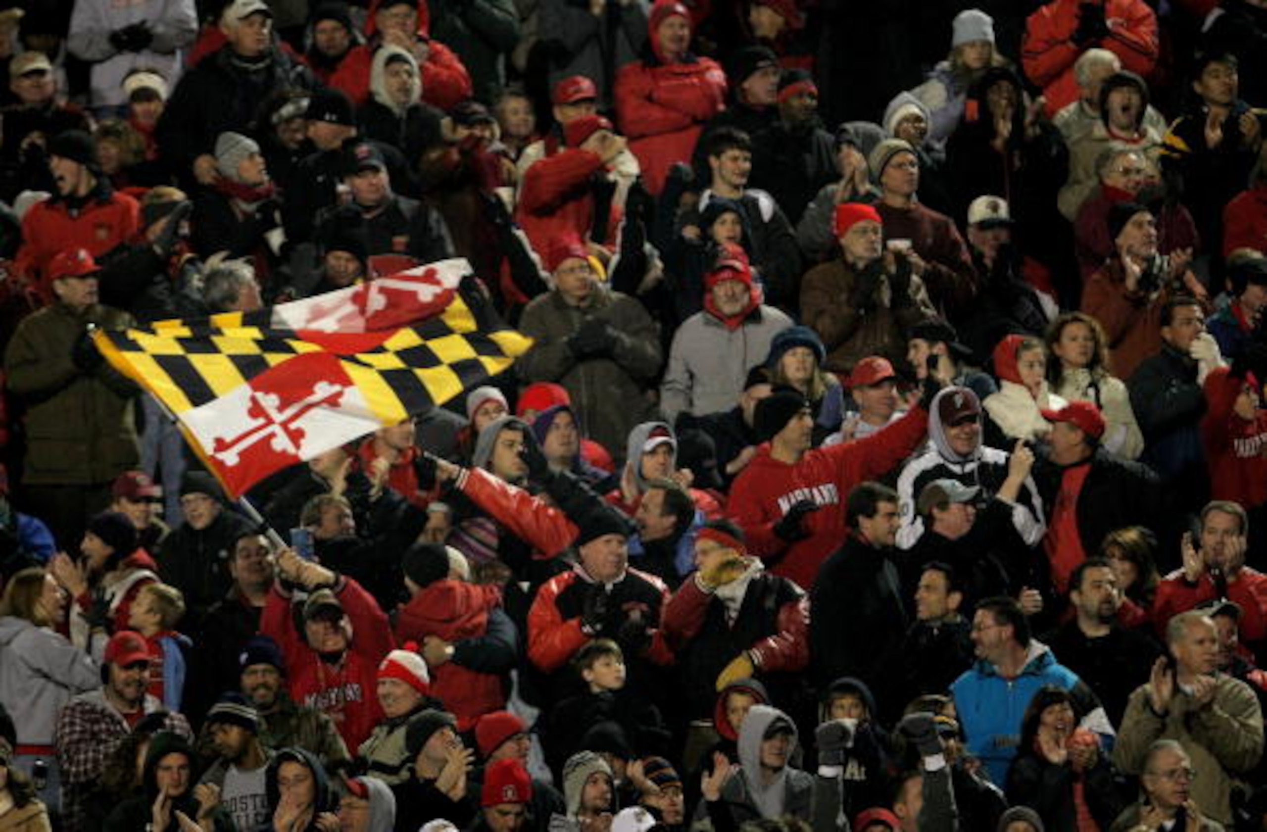 COLLEGE PARK, MD - NOVEMBER 10:  A Maryland fan waves the state flag as the Boston College Eagles square off against the Maryland Terrapins at Byrd Stadium on November 10, 2007 in College Park, Maryland.  (Photo by Doug Pensinger/Getty Images)