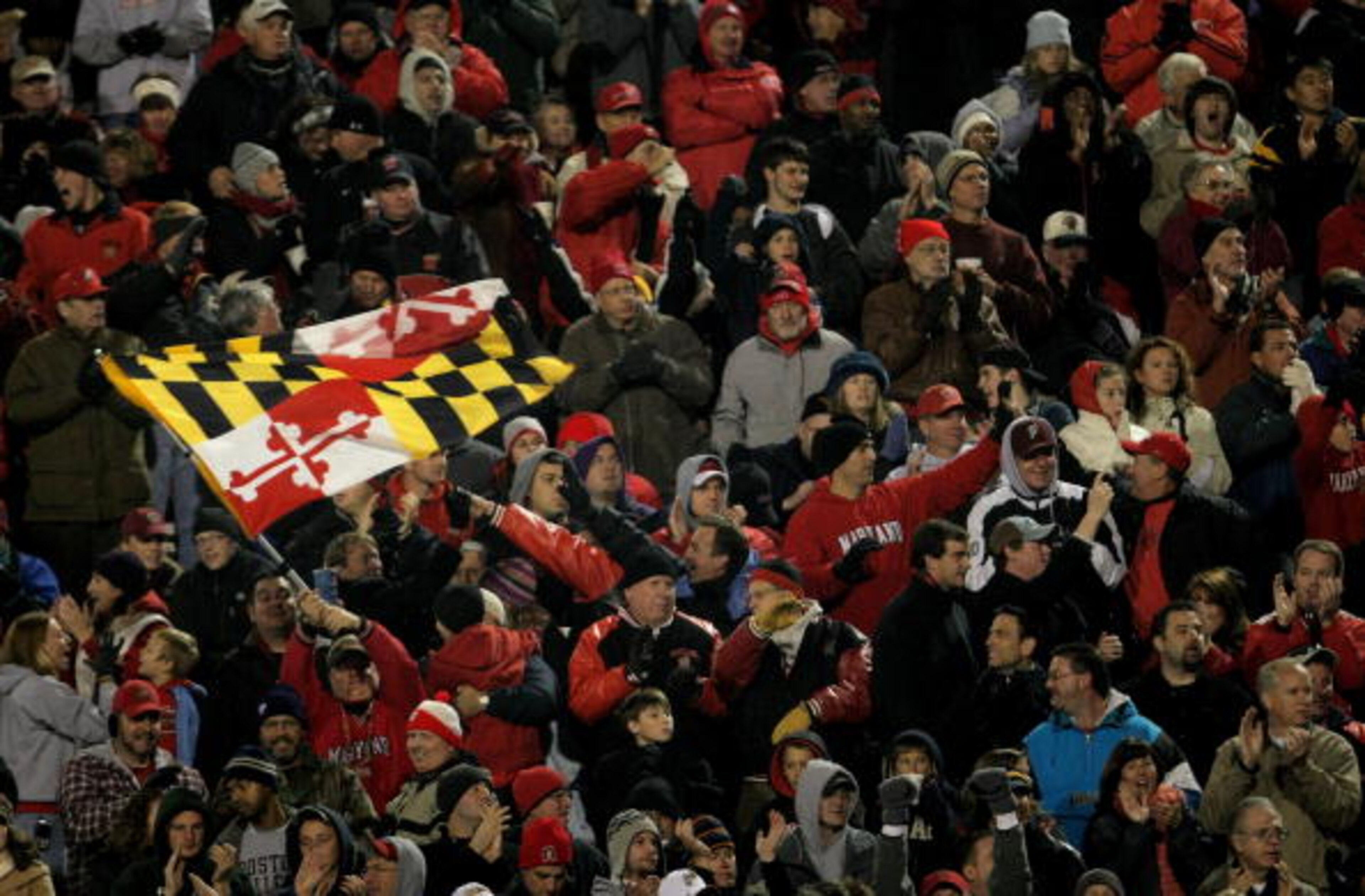 COLLEGE PARK, MD - NOVEMBER 10:  A Maryland fan waves the state flag as the Boston College Eagles square off against the Maryland Terrapins at Byrd Stadium on November 10, 2007 in College Park, Maryland.  (Photo by Doug Pensinger/Getty Images)