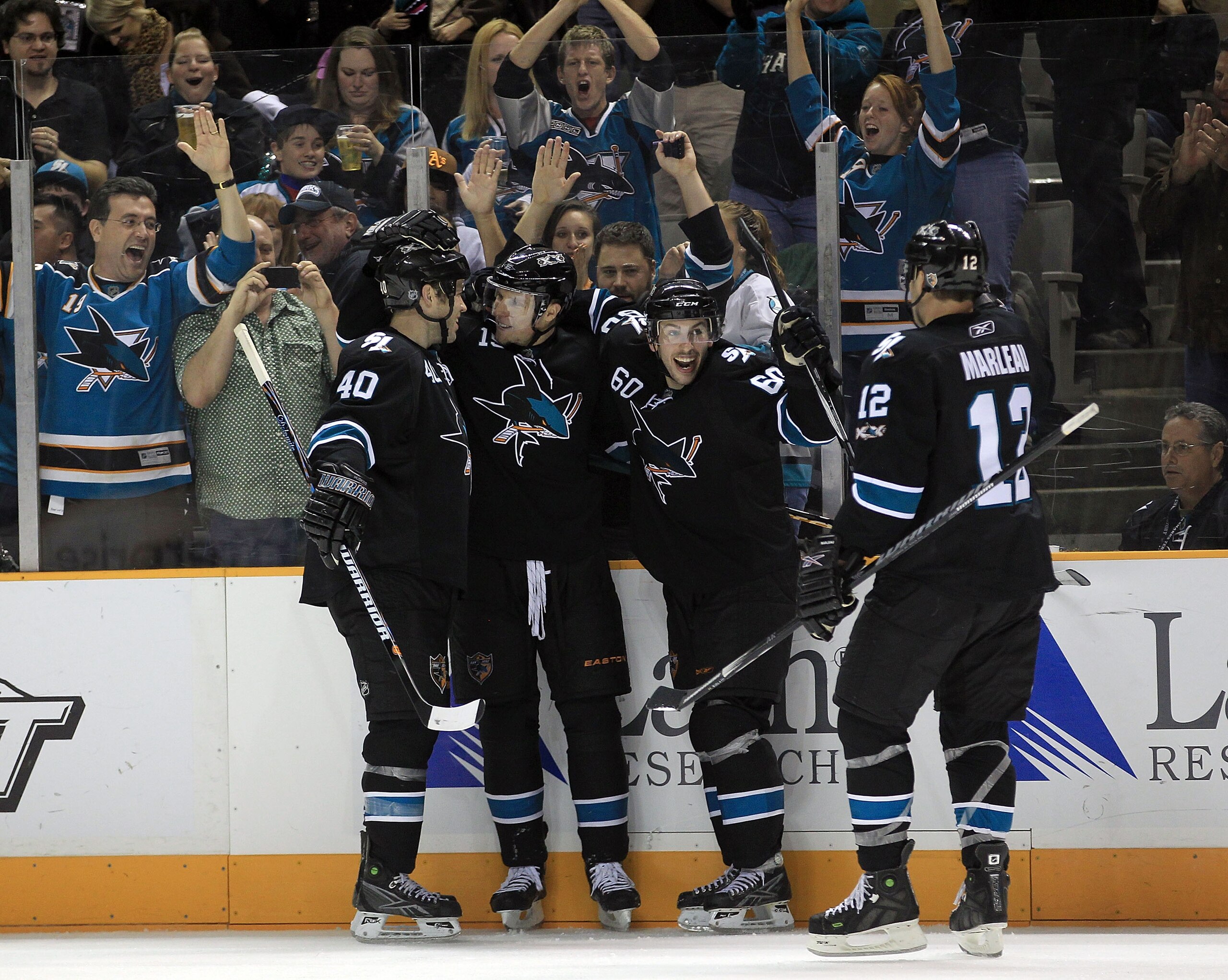 SAN JOSE, CA - NOVEMBER 15:  Dany Heatley #15 of the San Jose Sharks is congratulated by teammates Kent Huskins #40, Jason Demers #60 and Patrick Marleau #12  after he scored a goal during their game against the Los Angeles Kings at HP Pavilion on Novembe