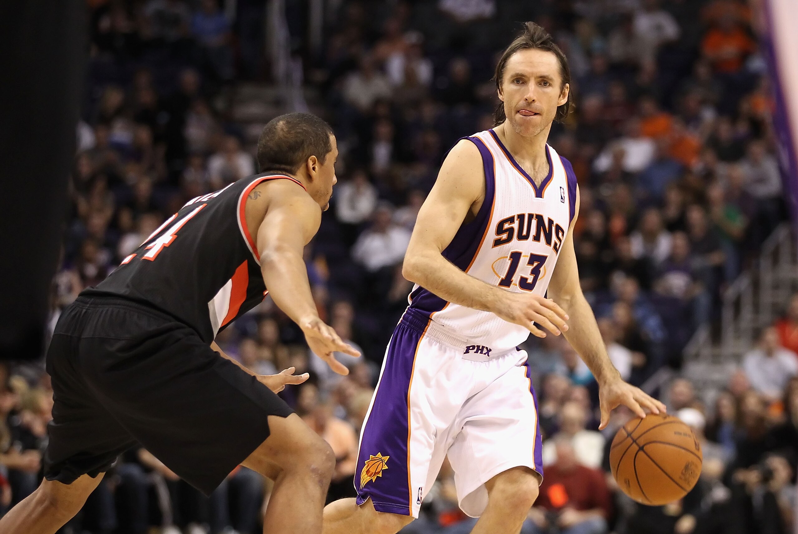 PHOENIX, AZ - JANUARY 14:  Steve Nash #13 of the Phoenix Suns handles the ball during the NBA game against the Portland Trail Blazers at US Airways Center on January 14, 2011 in Phoenix, Arizona. The Suns defeated the Trail Blazers 115-111. NOTE TO USER: