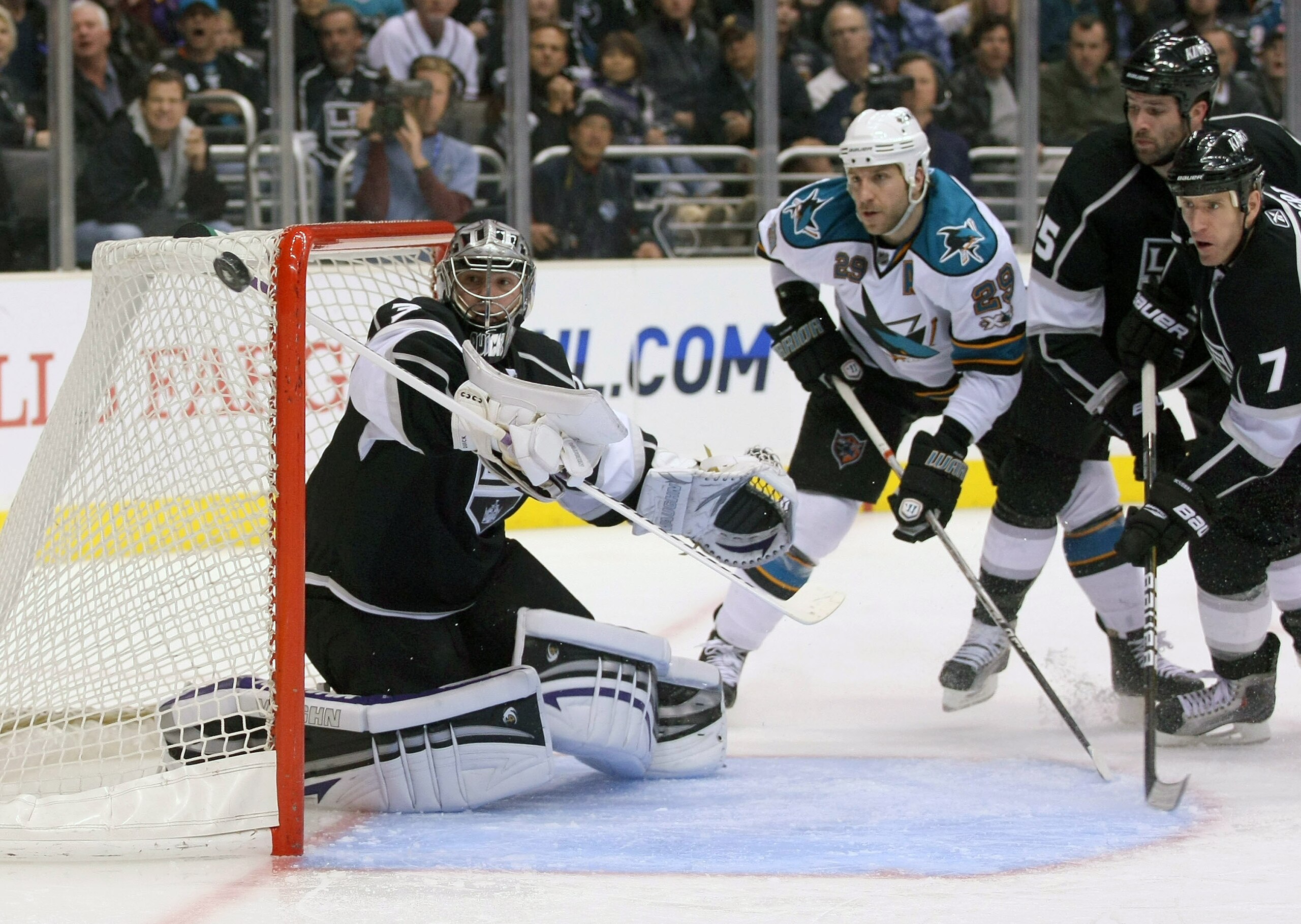 LOS ANGELES, CA - MARCH 24:  Goaltender Jonathan Quick #32 of the Los Angeles Kings watches the puck go wide of the net as Ryan Clowe #29 of the San Jose Sharks looks for the rebound during the NHL game at Staples Center on March 24, 2011 in Los Angeles,