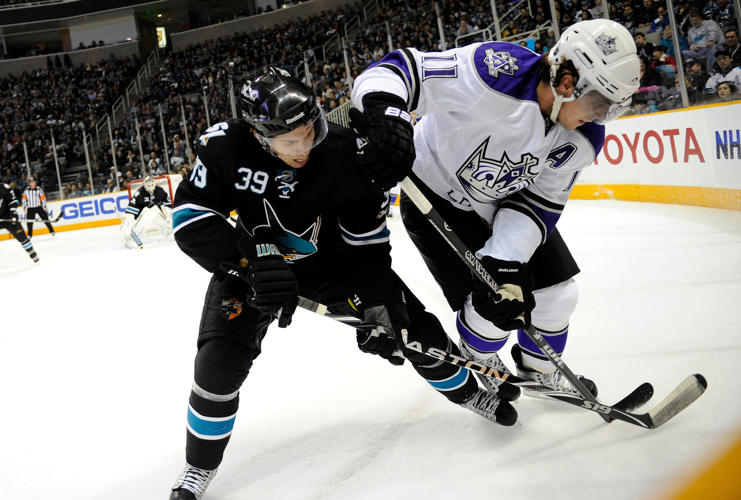 SAN JOSE, CA - DECEMBER 27: Anze Kopitar #11 of the Los Angeles Kings battles for the puck with Logan Couture #39 of the San Jose Sharks during an NHL hockey game at the HP Pavilion on December 27, 2010 in San Jose, California. The Kings won the game 4-0.