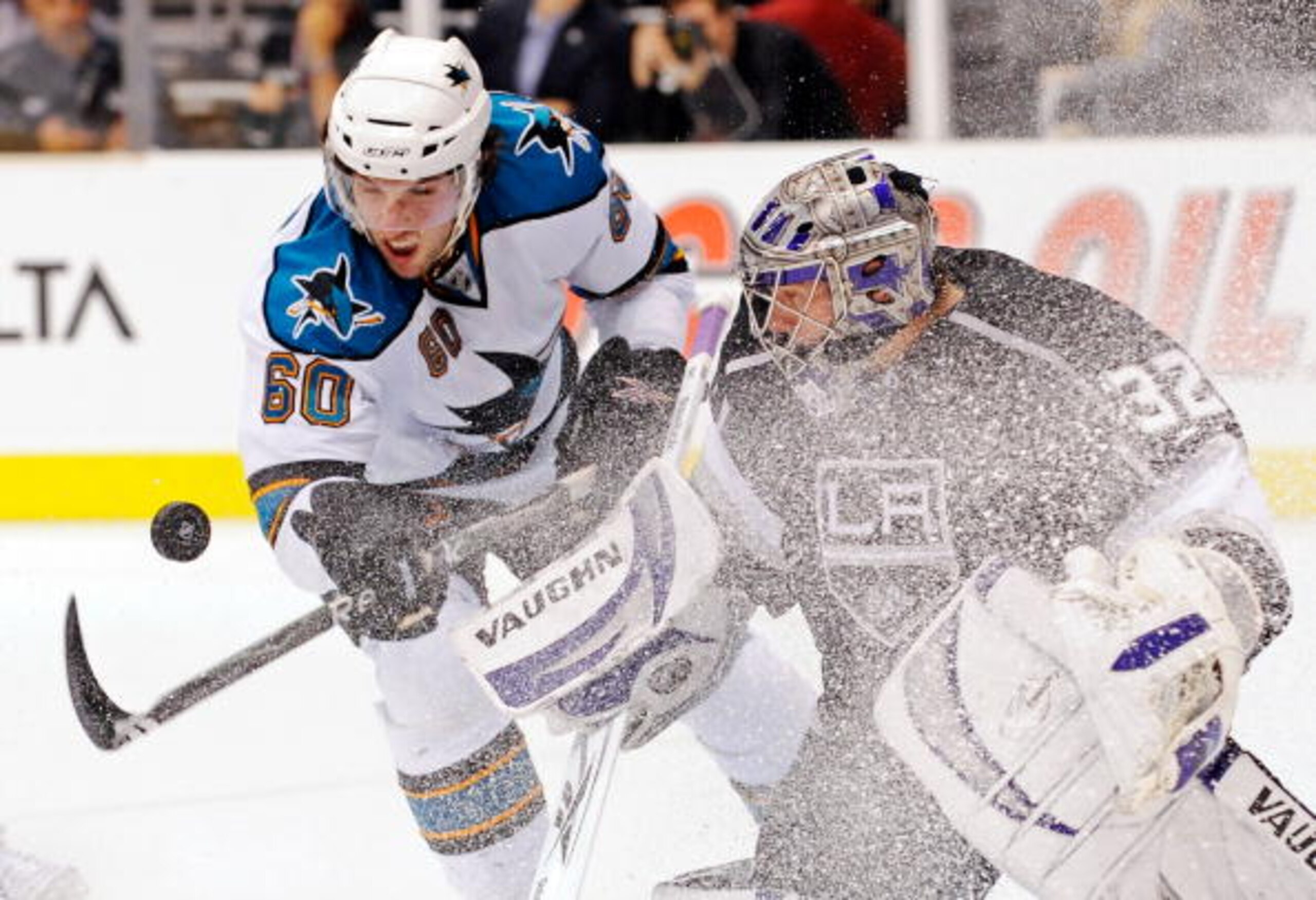 LOS ANGELES, CA - OCTOBER 06:  Jason Demers #60 of the San Jose Sharks tries to score against goalie Jonathan Quick #32 of the Los Angeles Kings during the first period of the NHL hockey game on October 6, 2009 in Los Angeles, California.  (Photo by Kevor
