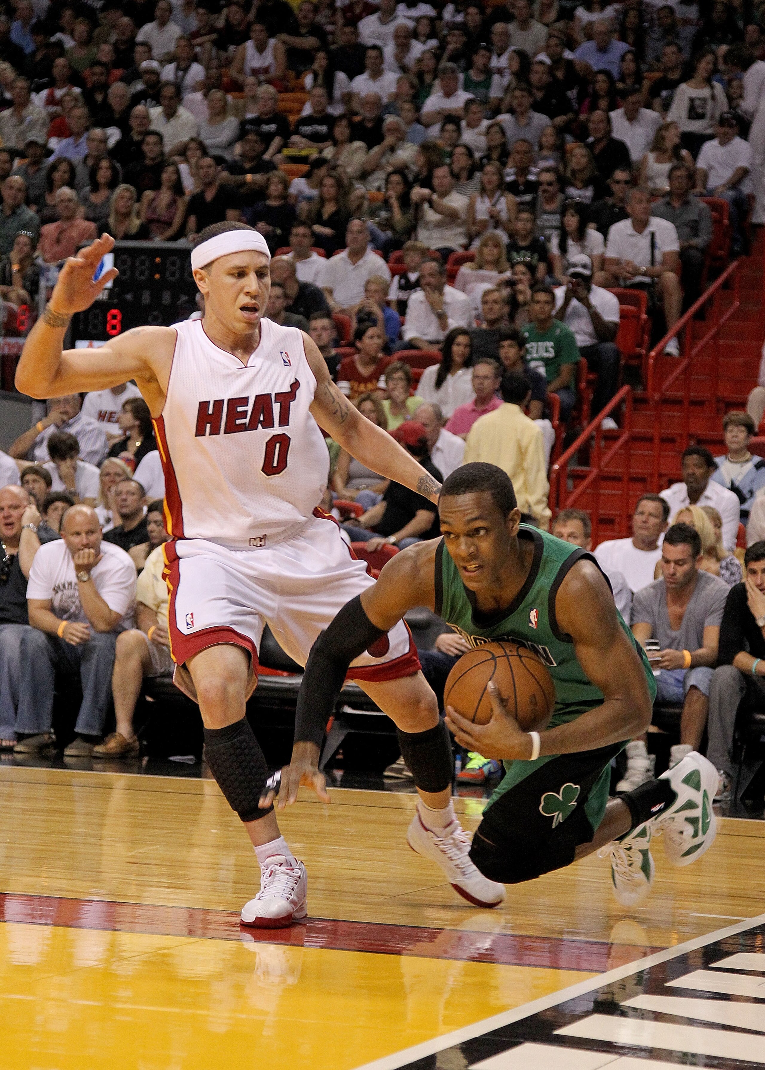 MIAMI, FL - APRIL 10:  Rajon Rondo #9 of the Boston Celtics is fouled by Mike Bibby #0 of the Miami Heat during a game at American Airlines Arena on April 10, 2011 in Miami, Florida. NOTE TO USER: User expressly acknowledges and agrees that, by downloadin