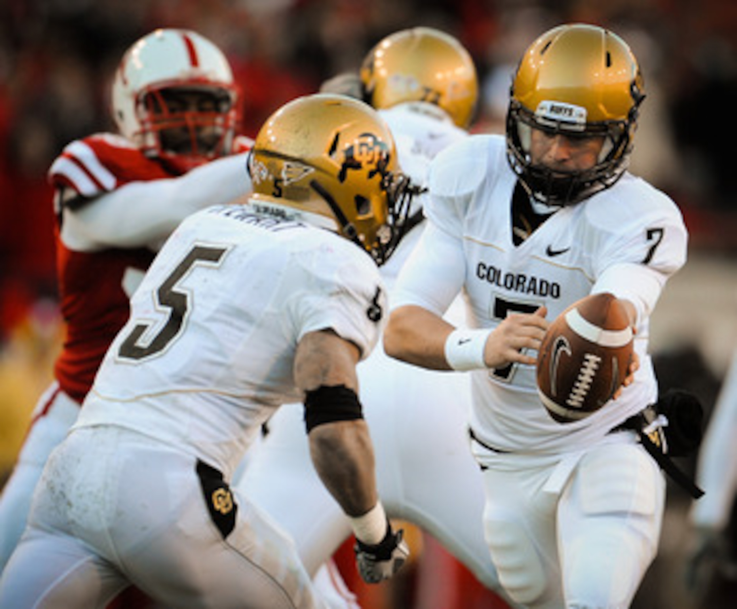 LINCOLN, NE - NOVEMBER 26: Cody Hawkins #7 hands the ball to teammate Rodney Stewart #5 of the Colorado Buffaloes during their game against the Colorado Buffaloes at Memorial Stadium on November 26, 2010 in Lincoln, Nebraska. Nebraska defeated Colorado 45