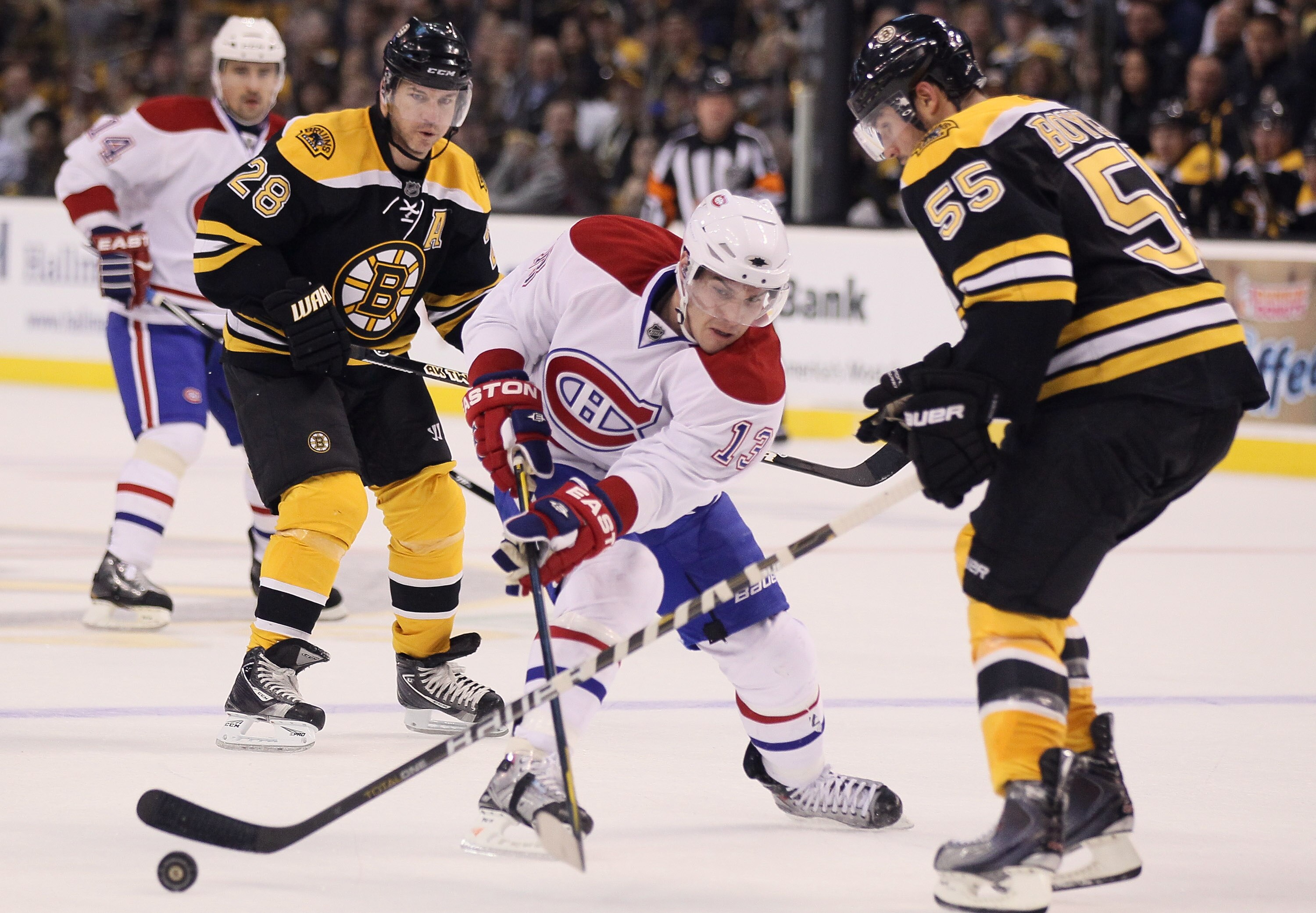 BOSTON, MA - MARCH 24:  Mike Cammalleri #13 of the Montreal Canadiens passes the puck as Johnny Boychuk #55 of the Boston Bruins defends on March 24, 2011 at the TD Garden in Boston, Massachusetts.  (Photo by Elsa/Getty Images)