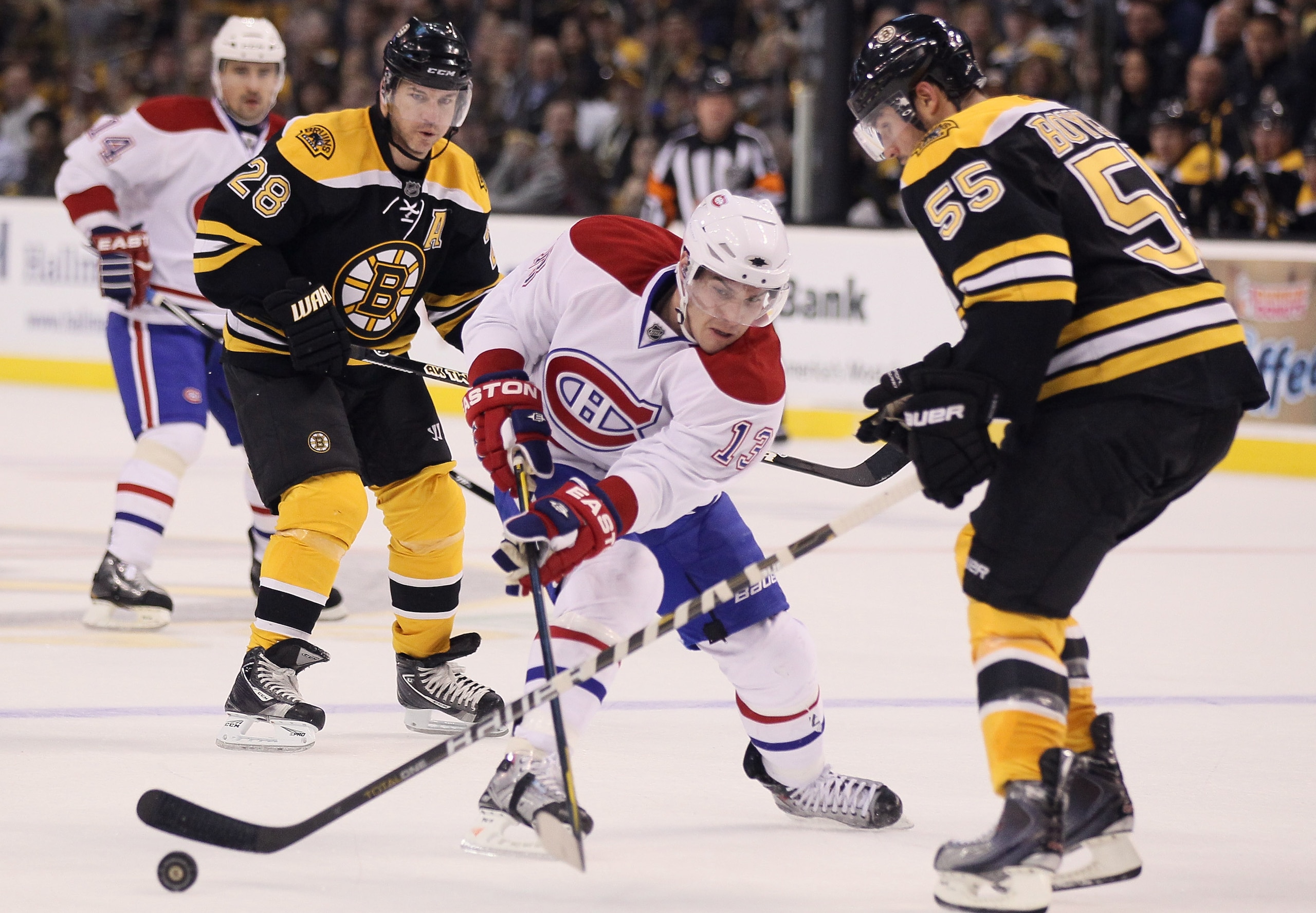 BOSTON, MA - MARCH 24:  Mike Cammalleri #13 of the Montreal Canadiens passes the puck as Johnny Boychuk #55 of the Boston Bruins defends on March 24, 2011 at the TD Garden in Boston, Massachusetts.  (Photo by Elsa/Getty Images)