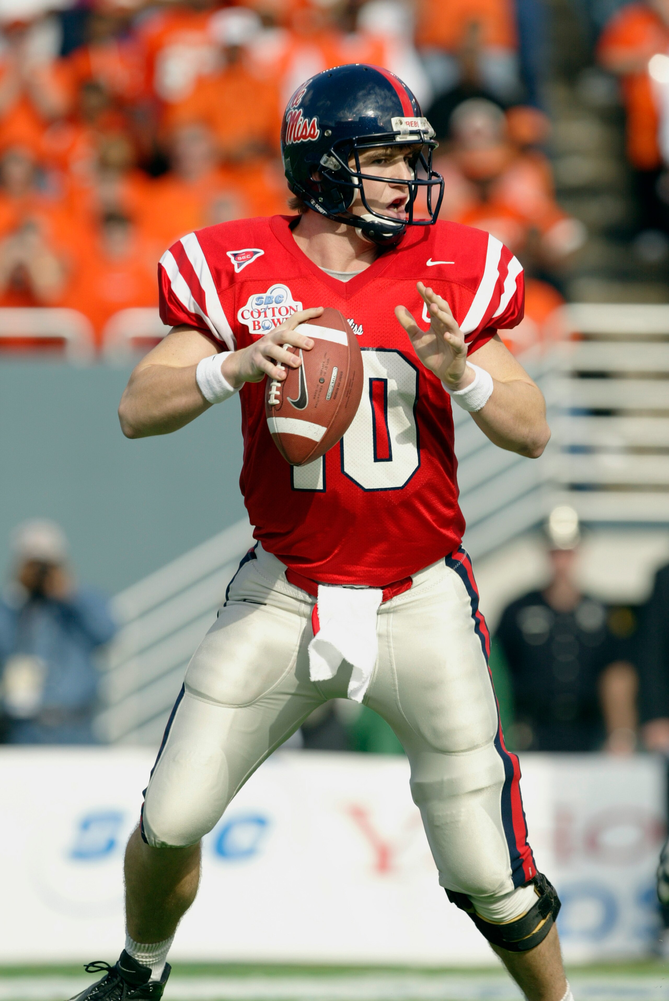 DALLAS - JANUARY 2:  Quarterback Eli Manning #10 of the Mississippi Rebels looks for the open receiver during the SBC Cotton Bowl against the Oklahoma State Cowboys on January 2, 2004 at the Cotton Bowl in Dallas, Texas.  'Ole Miss defeated Oklahoma State