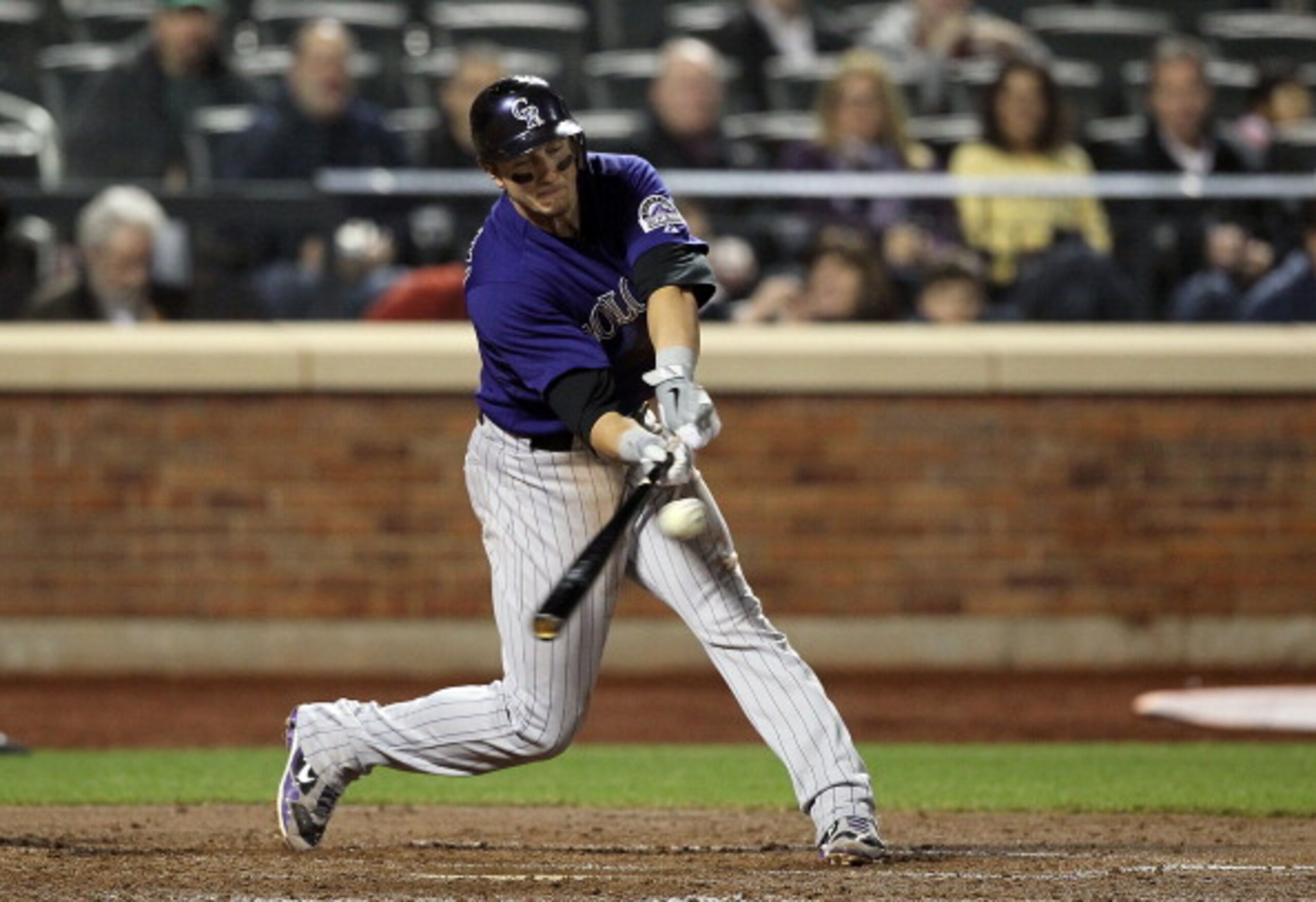NEW YORK, NY - APRIL 11:  Troy Tulowitzki #2 of the Colorado Rockies connects on a third inning RBI single against the New York Mets on April 11, 2011 at Citi Field in the Flushing neighborhood of the Queens borough of New York City.  (Photo by Jim McIsaa