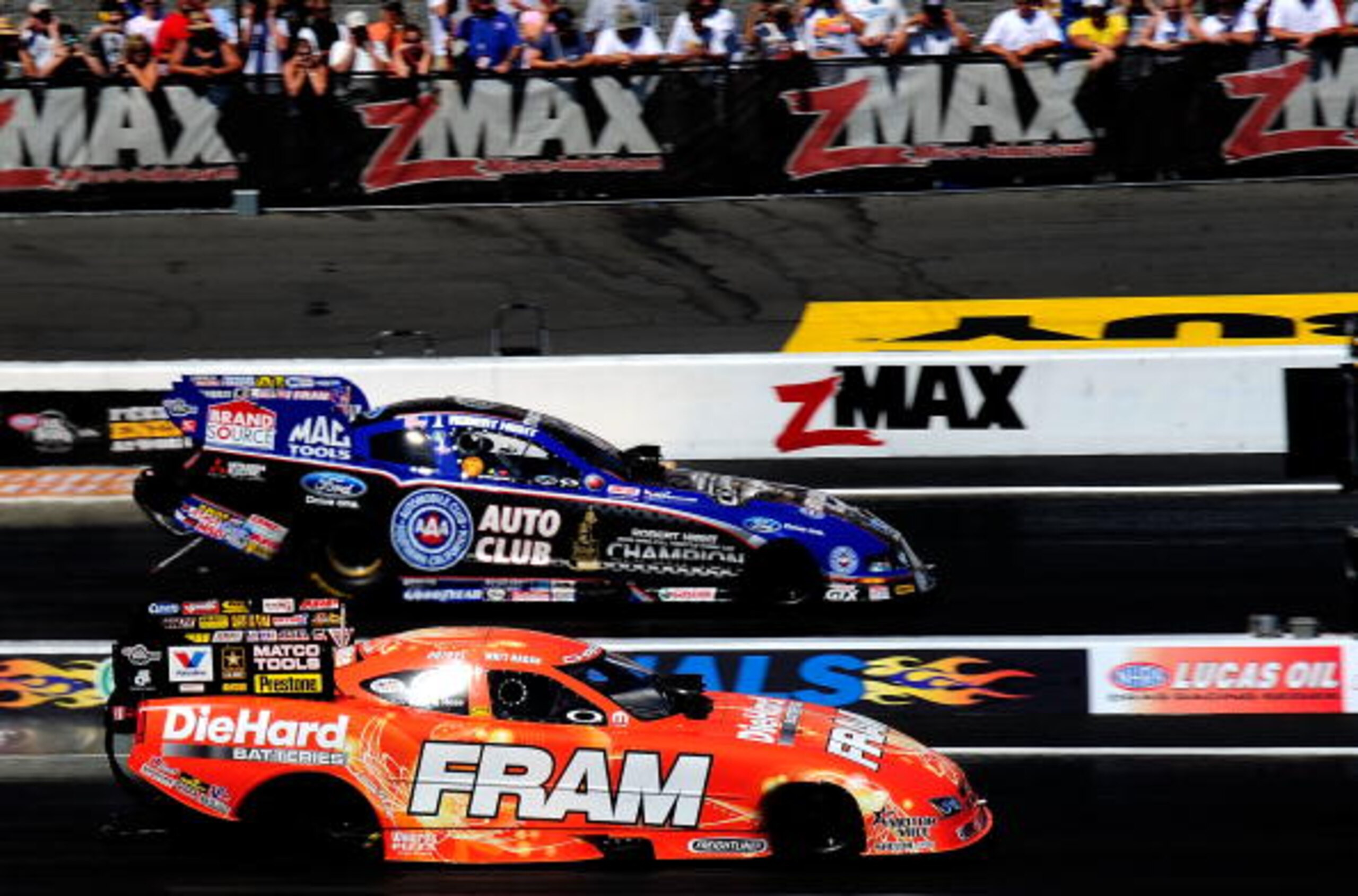CONCORD, NC - SEPTEMBER 19:  Matt Hagan, drives the Fram Funny Car against Robert Hight, driver of the Auto Club Funny Car during the O'Reilly Auto Parts NHRA Nationals at zMax Dragway on September 19, 2010 in Concord, North Carolina.  (Photo by Rusty Jar
