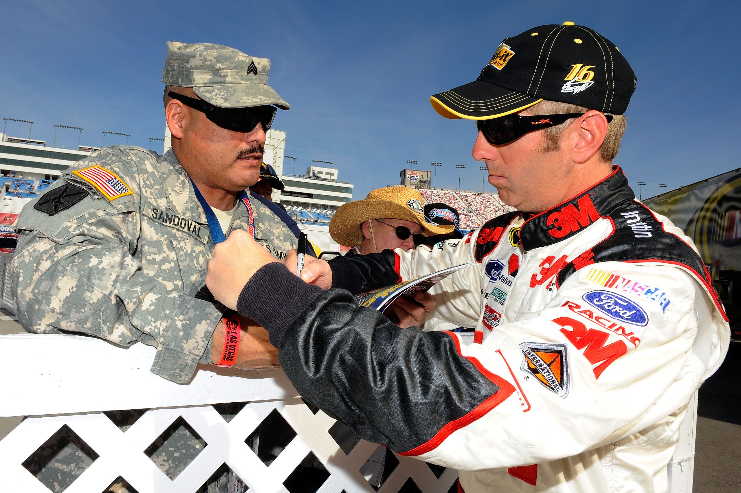 LAS VEGAS, NV - MARCH 05:  Greg Biffle, driver of the #16 3M Post-it Ford, signs his autograph for a fan during practice for the NASCAR Sprint Cup Series Kobalt Tools 400 at Las Vegas Motor Speedway on March 5, 2011 in Las Vegas, Nevada.  (Photo by Jared