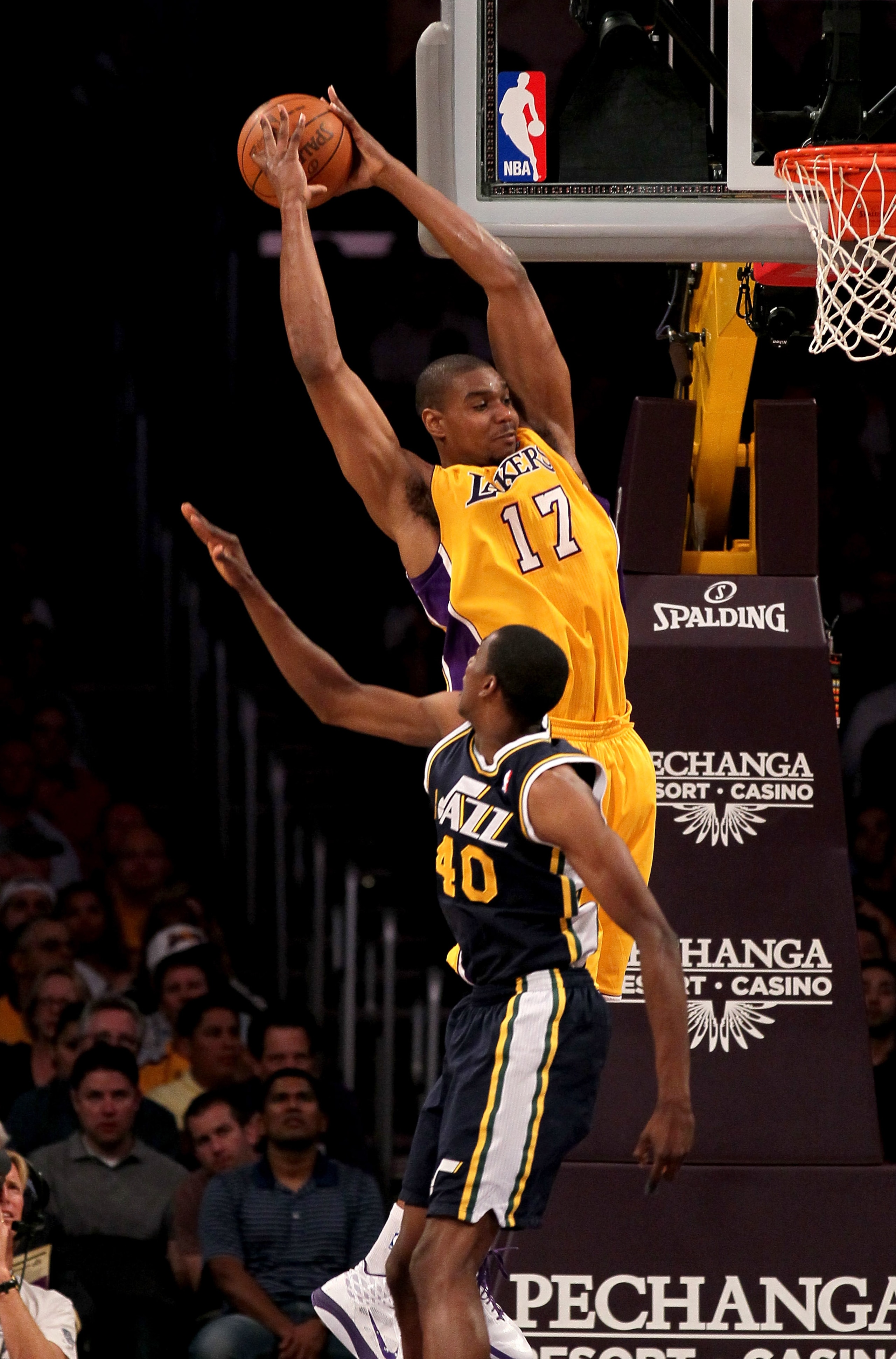 LOS ANGELES, CA - APRIL 5:  Andrew Bynum #17 of the Los Angeles Lakers jumps to catch a pass over Jeremy Evans #40 of the Utah Jazz at Staples Center on April 5, 2011 in Los Angeles, California.  NOTE TO USER: User expressly acknowledges and agrees that,