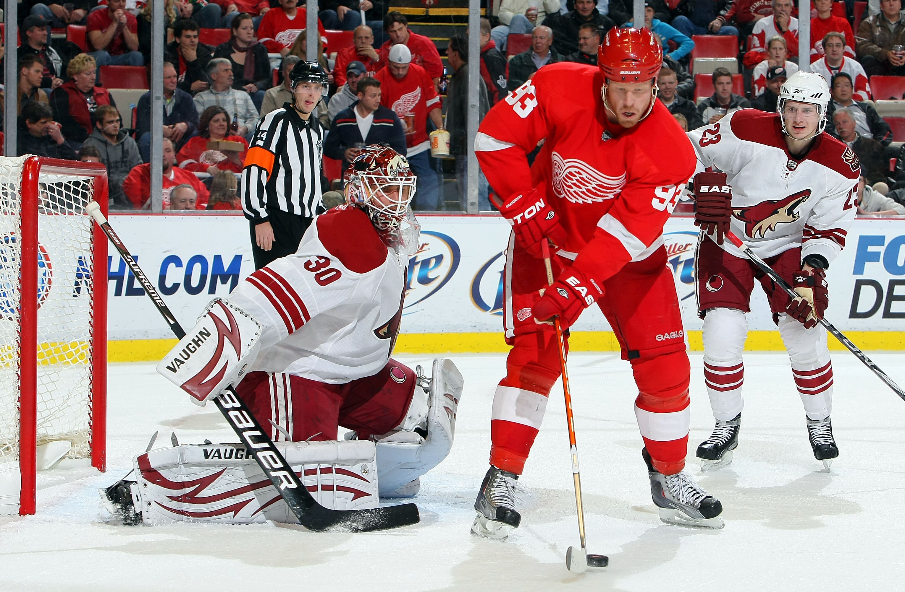 DETROIT - OCTOBER 28:  Oliver Ekman-Larsson #23 of the Phoenix Coyotes looks on as Johan Franzen #93 of the Detroit Red Wings tips a shot past for a goal against Ilya Bryzgalov #30 of the Phoenix Coyotes during their NHL game at Joe Louis Arena on October