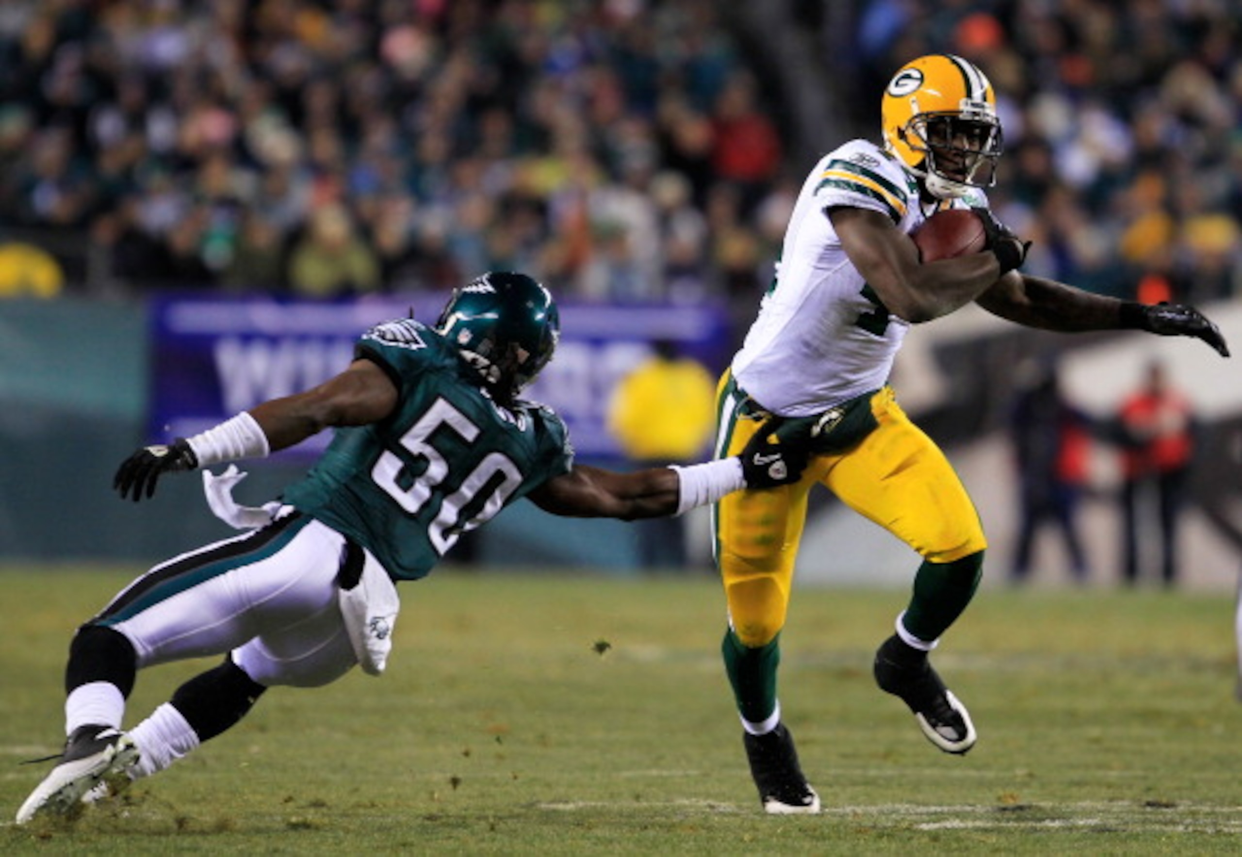 PHILADELPHIA, PA - JANUARY 09:  James Starks #44 of the Green Bay Packers avoids the tackle of Ernie Sims #50 of the Philadelphia Eagles during the 2011 NFC wild card playoff game at Lincoln Financial Field on January 9, 2011 in Philadelphia, Pennsylvania