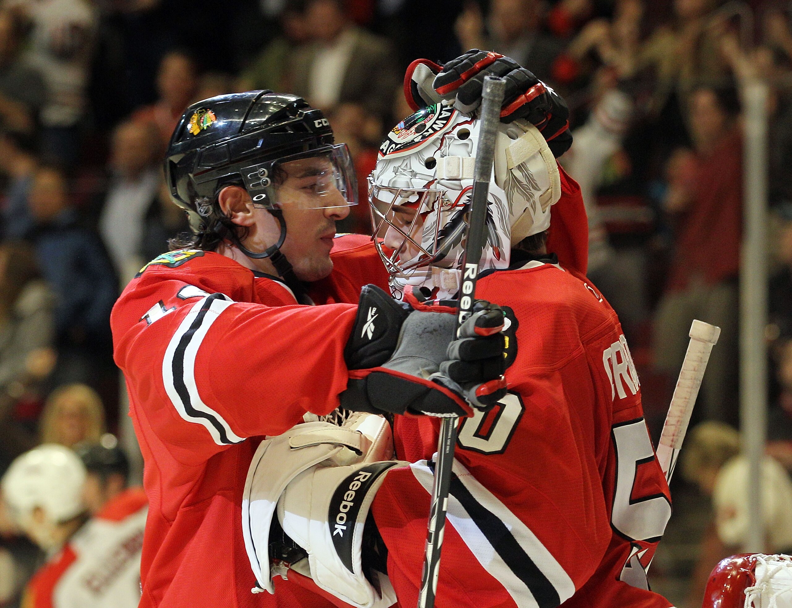 CHICAGO, IL - MARCH 23: Chris Campoli #14 and Corey Crawford #50 of the Chicago Blackhawks celebrate their win over the Florida Panthers at the United Center on March 23, 2011 in Chicago, Illinois. The Blackhawks defeated the Panthers 4-0.  (Photo by Bruc