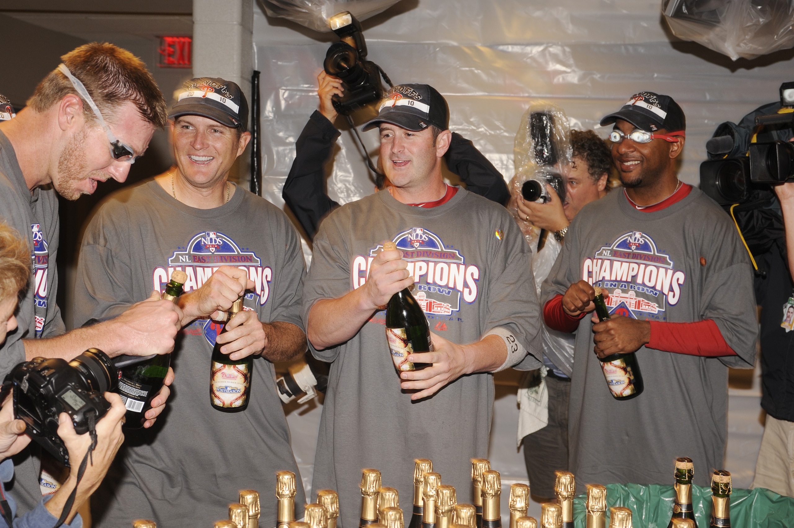 WASHINGTON - SEPTEMBER 27:  Roy Halliday, Mike Sweeney, Brian Schneider and Ben Francisco of the Philadelphia Phillies celebrate clinching the National League east title after a baseball game against the Washington Nationals on September 27, 2010 at Natio