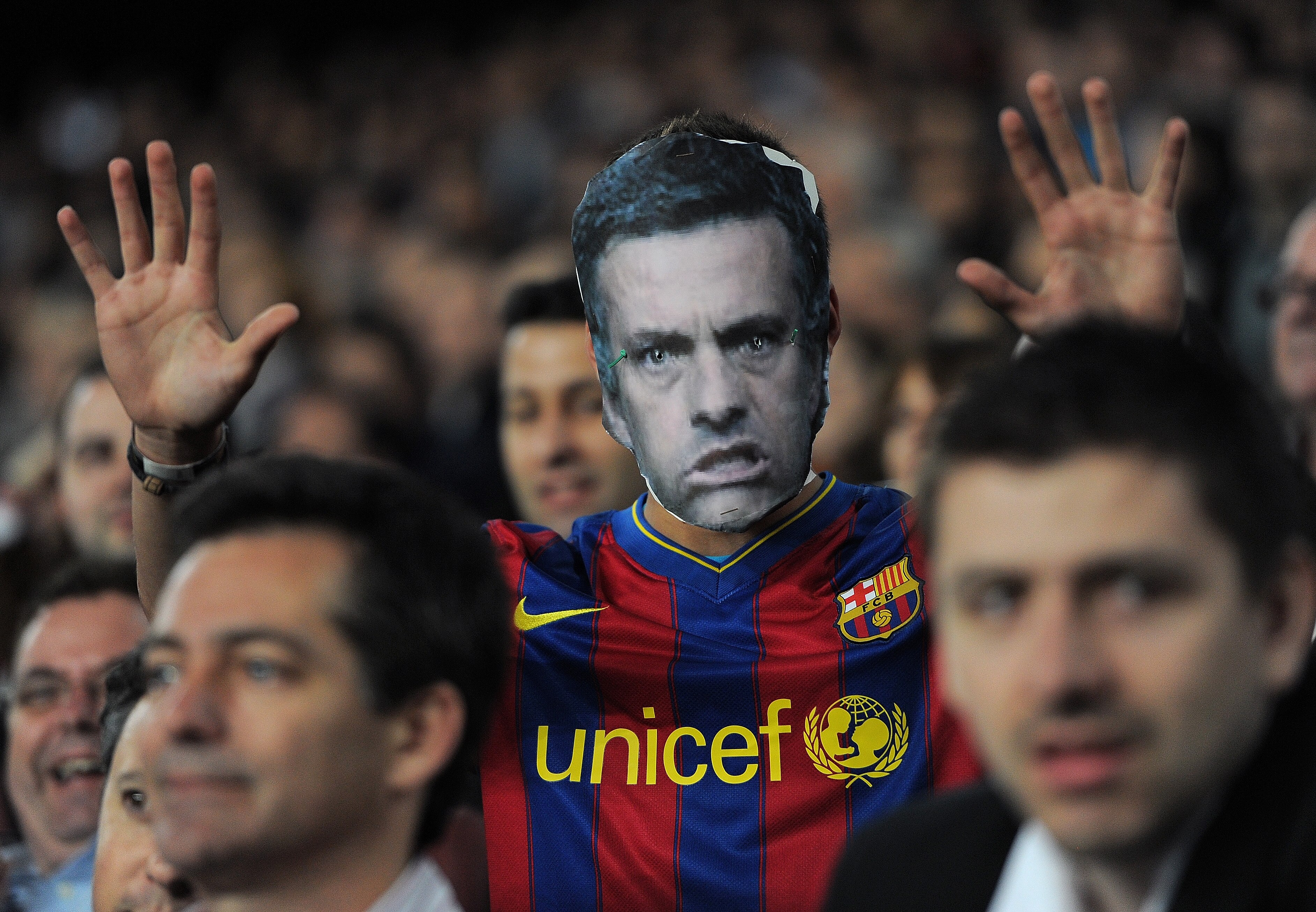 BARCELONA, SPAIN - APRIL 06:  A Barcelona fan with a cardboard mask of Real Madrid head coach Jose Mourinho follows the UEFA Champions League quarter final first leg match between Barcelona and Shakhtar Donetsk at the Camp Nou stadium on April 6, 2011 in
