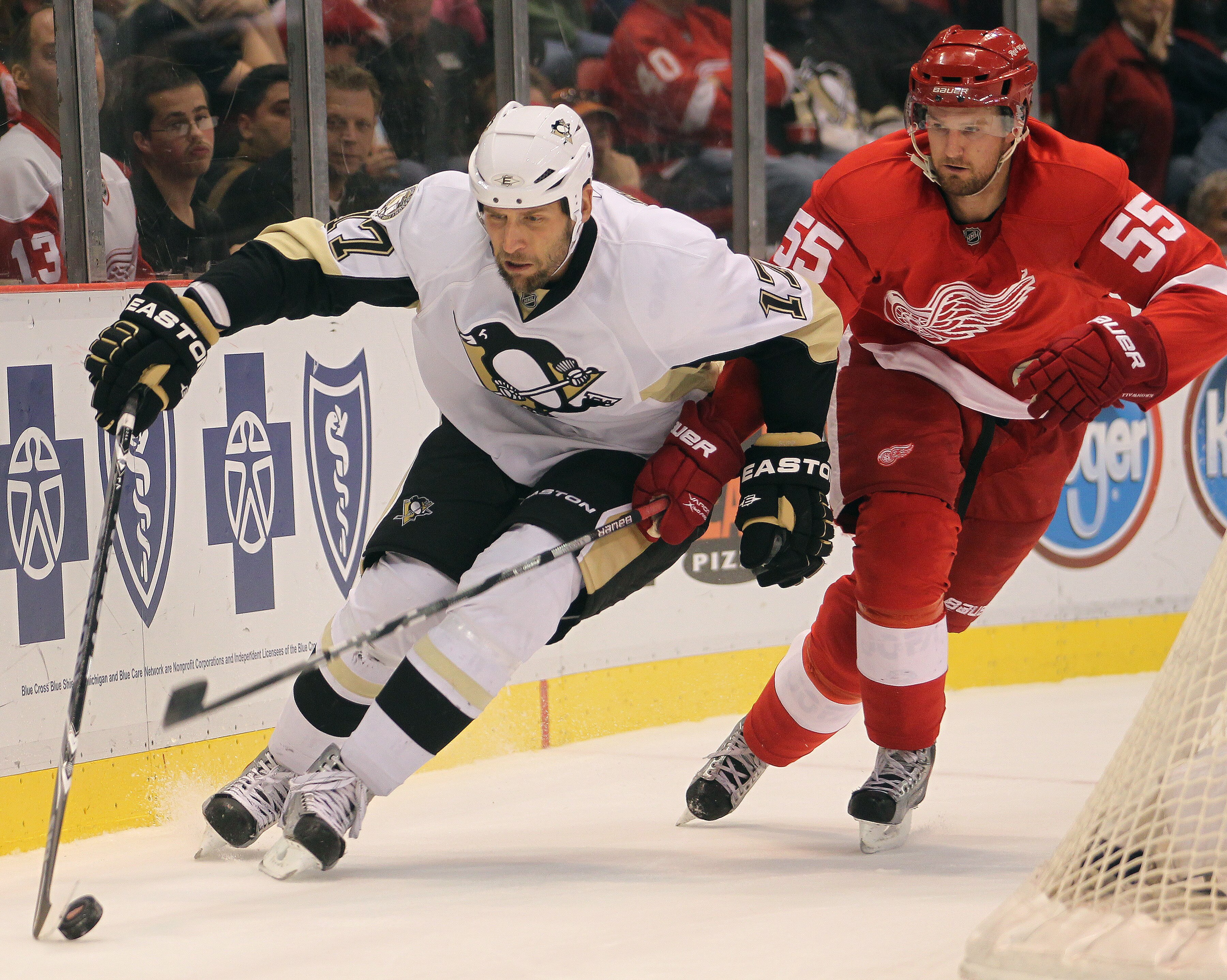 DETROIT, MI - OCTOBER 03:  Niklas Kronwall #55 of the Detroit Red Wings tries to check Mike Rupp #17 of the Pittsburgh Penguins in a preseason game on October 3, 2010 at the Joe Louis Arena in Detroit, Michigan. The Penguins defeated the Red Wings 5-2. (P