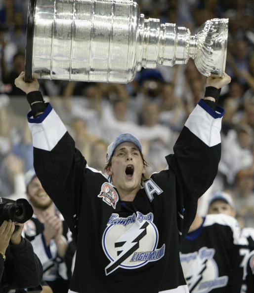 TAMPA, FL - JUNE 7:  Vincent Lecavalier #4 of the Tampa Bay Lightning holds the Stanley Cup above his head after the victory over the Calgary Flames in Game seven of the NHL Stanley Cup Finals on June 7, 2004 at the St. Pete Times Forum in Tampa, Florida.