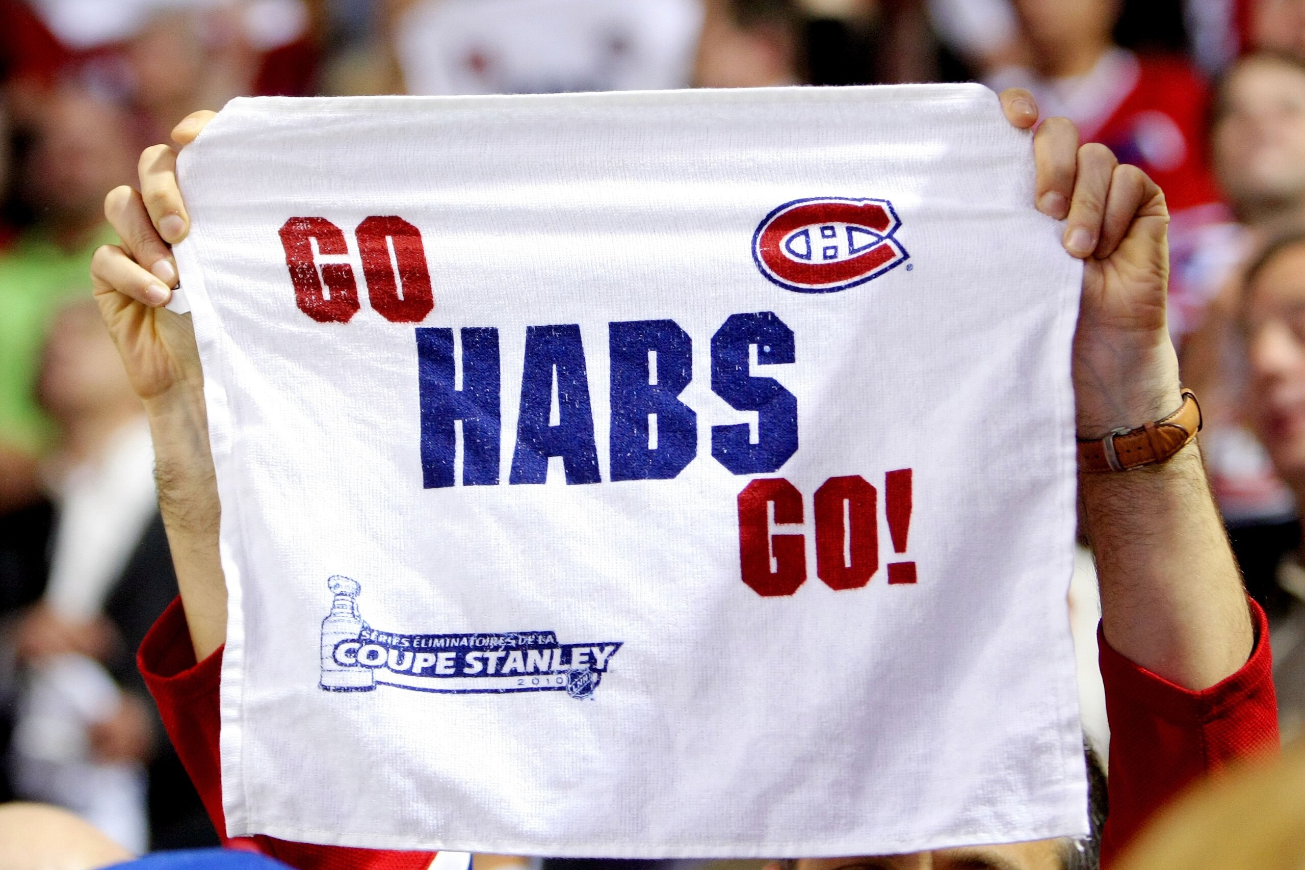 MONTREAL, QC - MAY 20:  A fan of the Montreal Canadiens holds up a towel reading 'Go Habs Go!' during Game 3 of the Eastern Conference Finals against the Philadelphia Flyers during the 2010 NHL Stanley Cup Playoffs at Bell Centre on May 20, 2010 in Montre