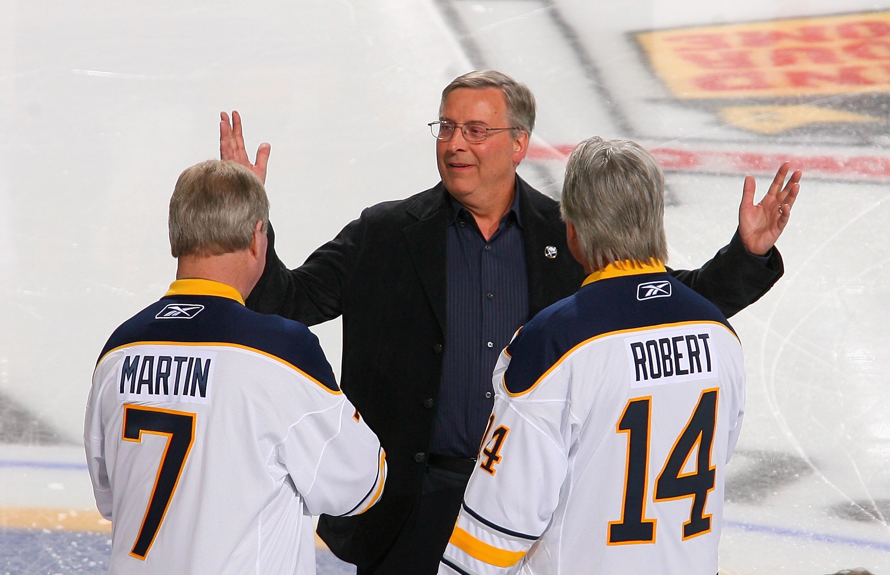 BUFFALO, NY - FEBRUARY 23:  New Buffalo Sabres owner Terry Pegula reacts as  former Sabres palyers Rene Robert #14 and  Rick Martin #7 skate out to meet him  during pre game ceremonies prior to play against the Atlanta Thrashers at HSBC Arena on February