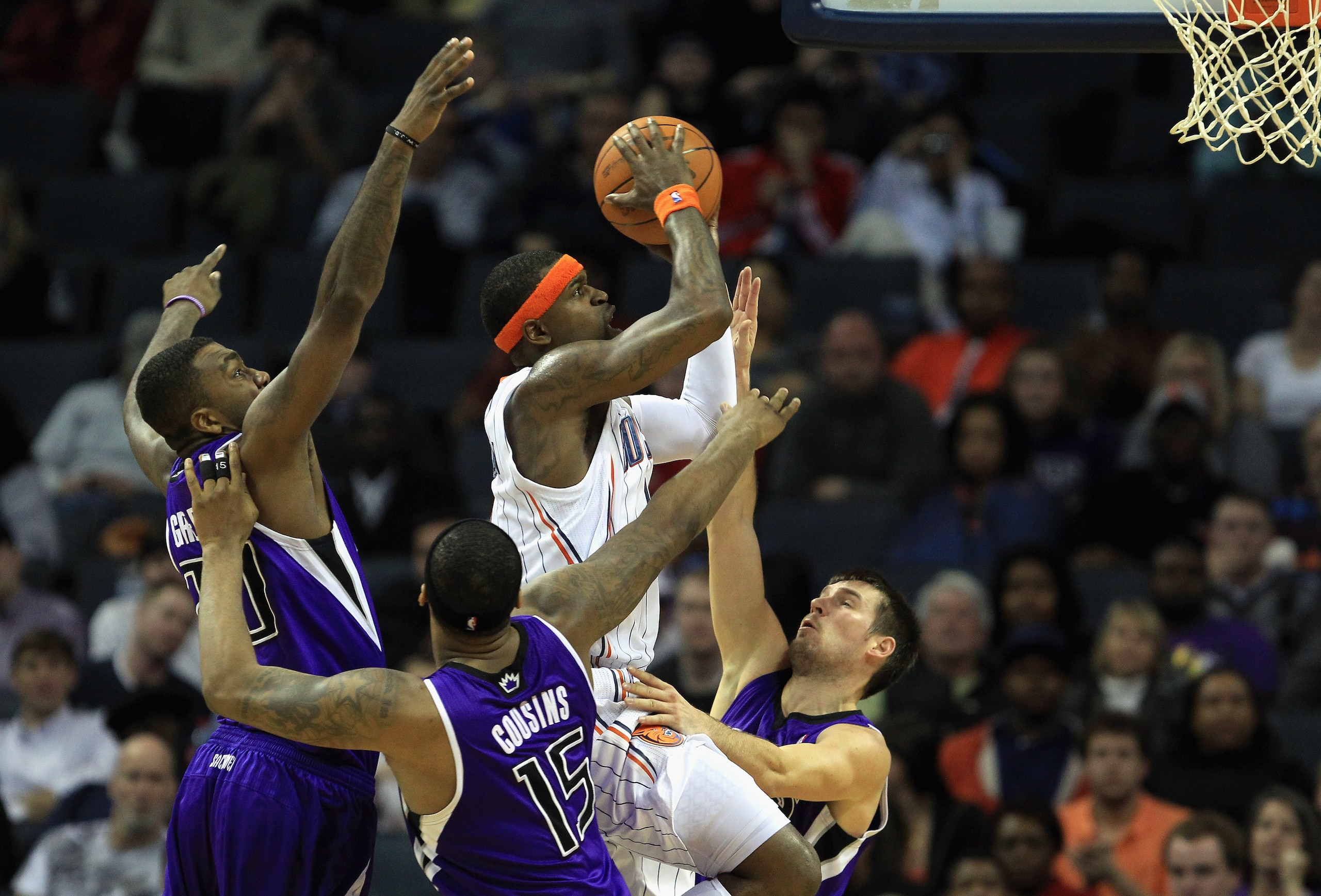 CHARLOTTE, NC - FEBRUARY 25:  Stephen Jackson #1 of the Charlotte Bobcats drives to the basket against teammates Donte Greene #20 DeMarcus Cousins #15 and Beno Udrih #19 of the Sacramento Kings during their game at Time Warner Cable Arena on February 25,