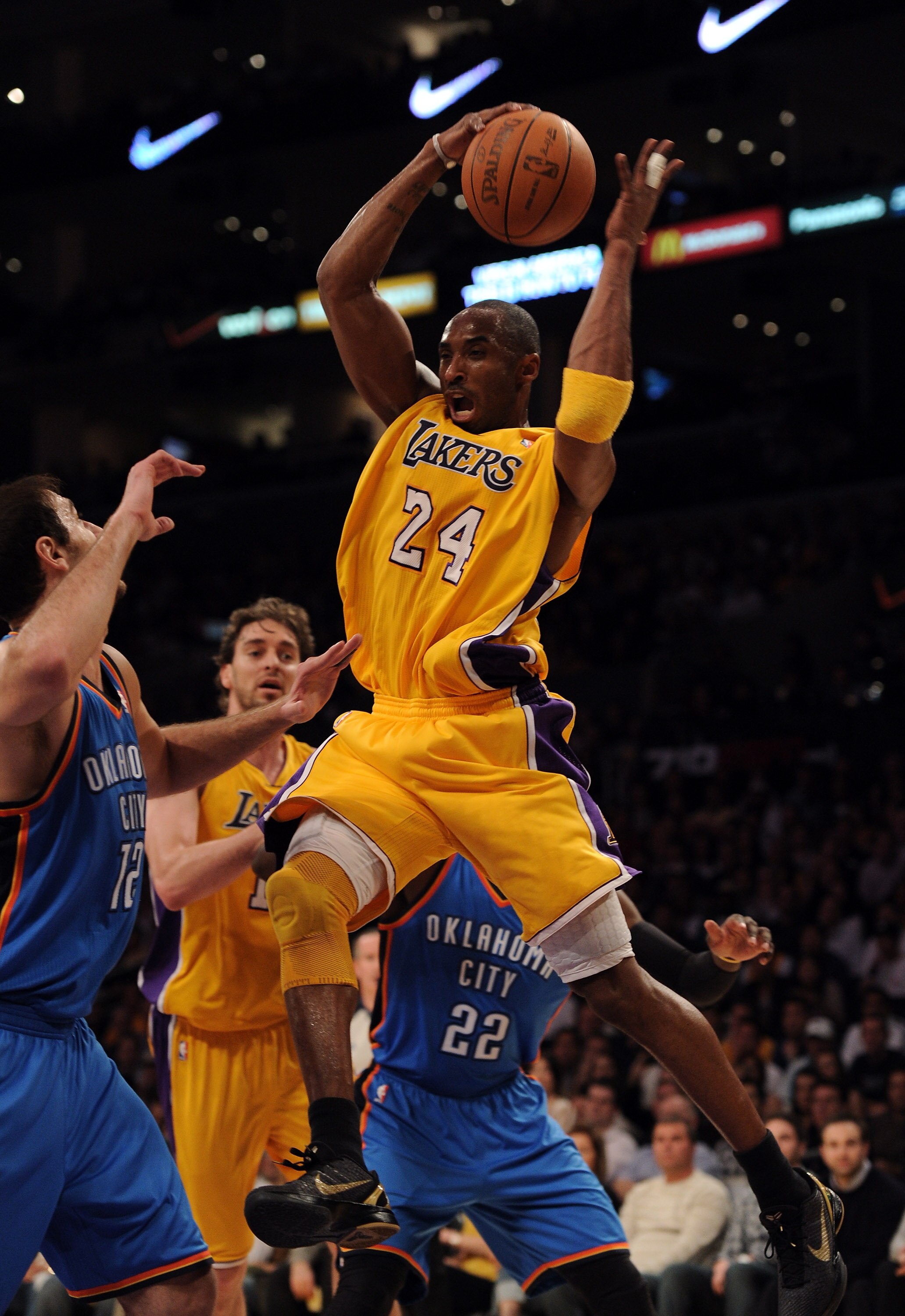 LOS ANGELES, CA - JANUARY 17:  Kobe Bryant #24 of the Los Angeles Lakers grabs a rebound in front of Nenad Krstic #12 of the Oklahoma City Thunder at the Staples Center on January 17, 2011 in Los Angeles, California.  (Photo by Harry How/Getty Images)   N